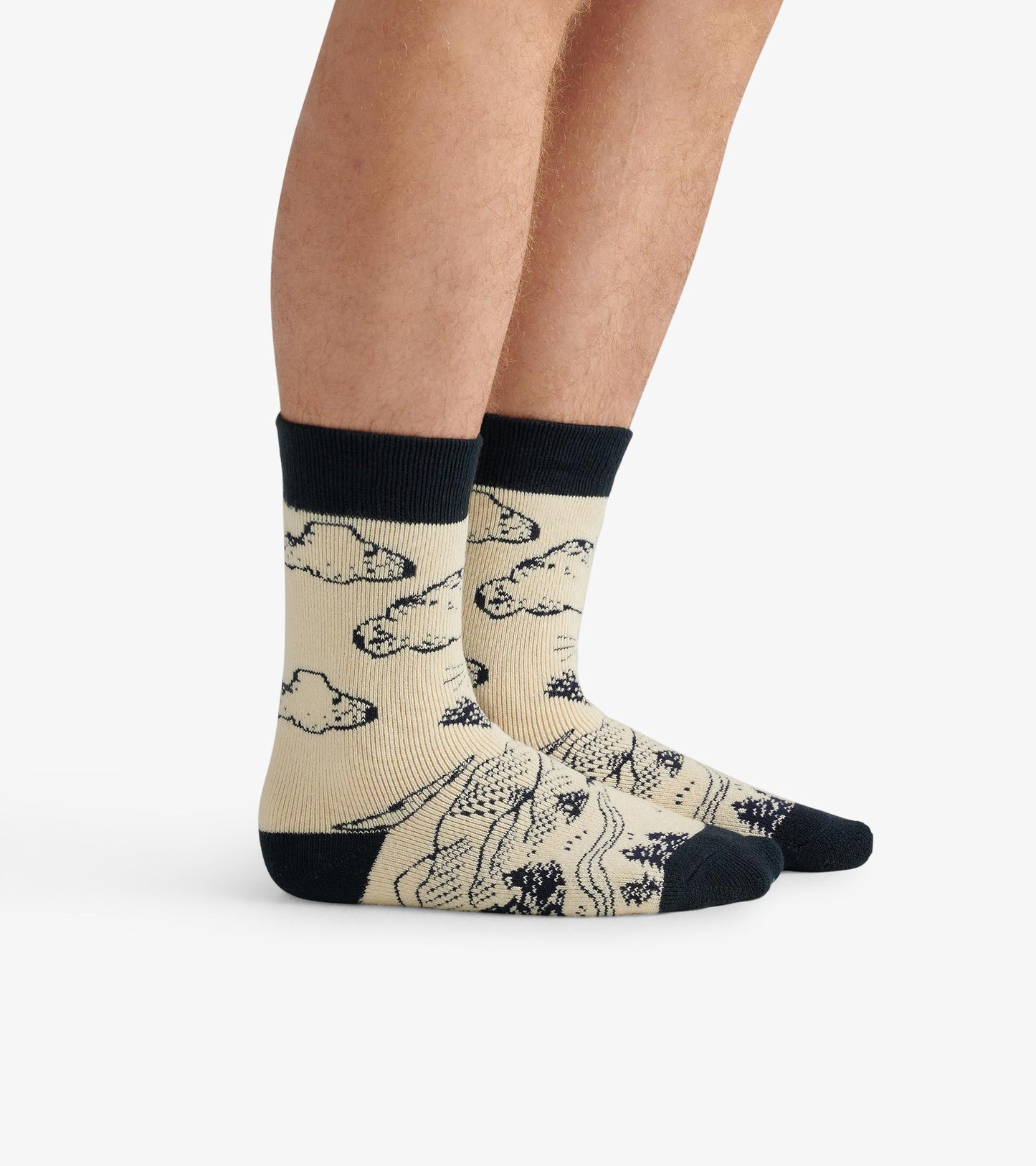 Beige cozy socks featuring a grizzly bear and cloud pattern, with a dark navy cuff and toe. One size fits most.