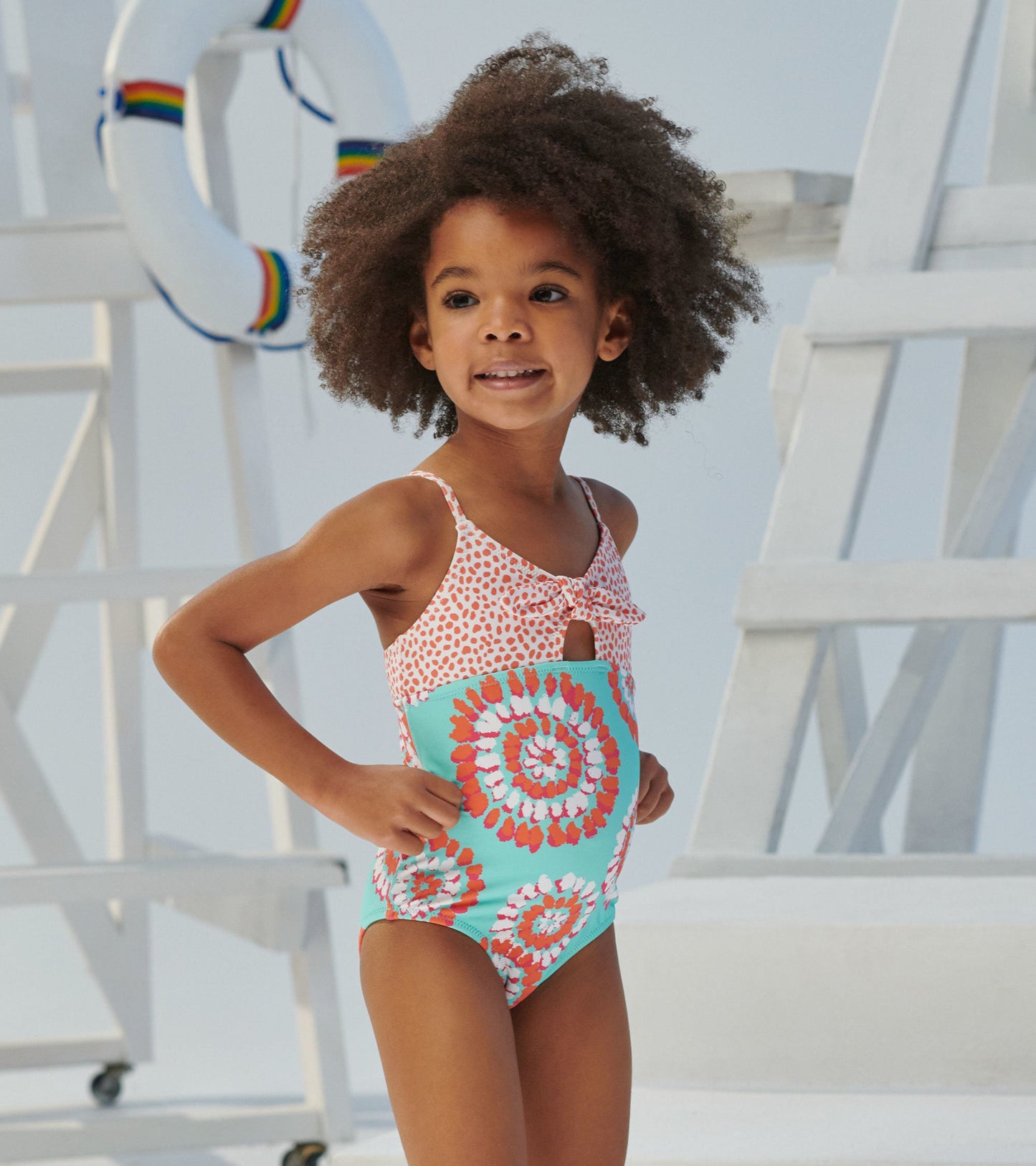 Colorful tie-front swimsuit featuring a pink and white spotted top and a turquoise bottom with mandala patterns.