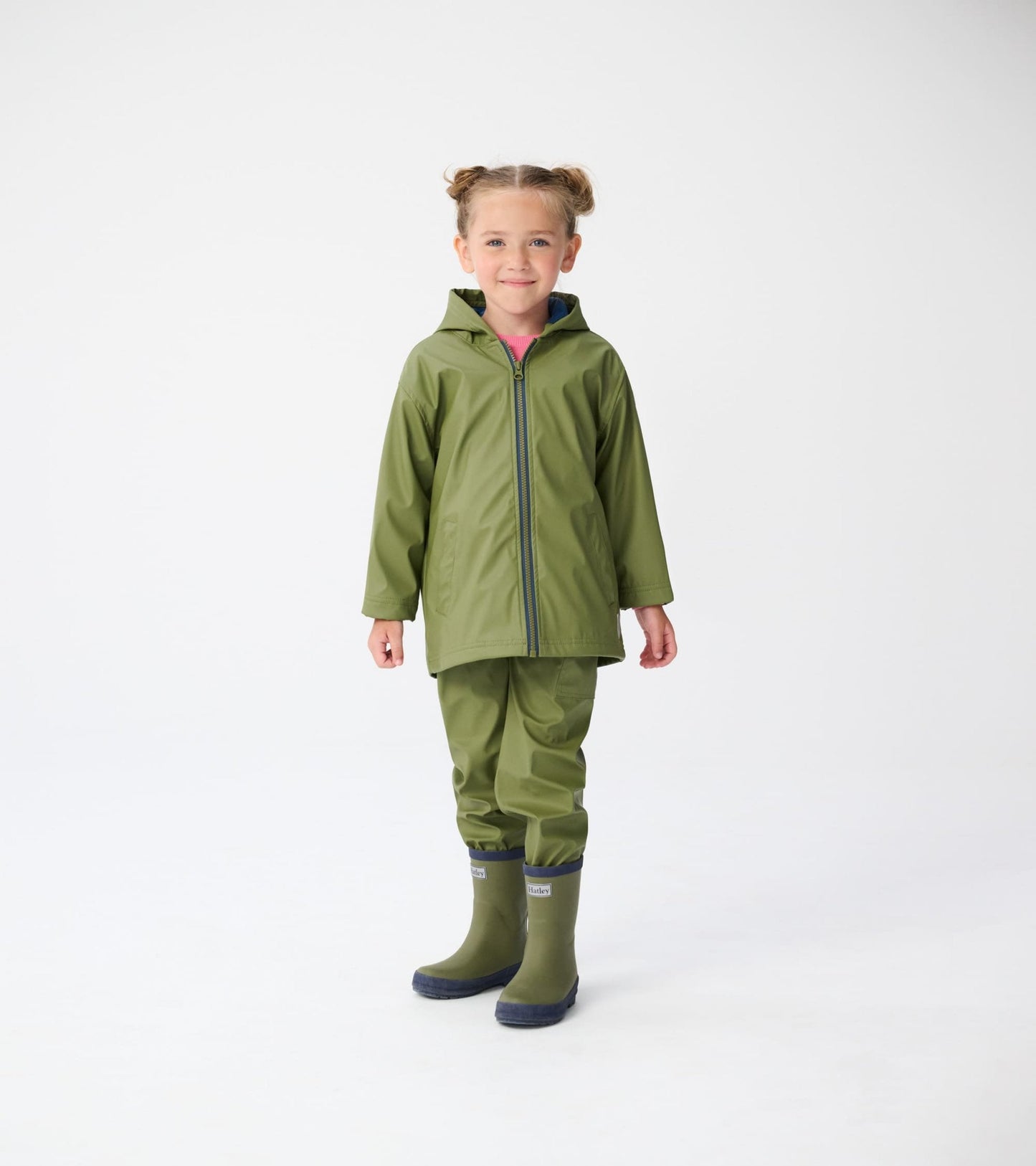 Forest green zip-up raincoat with a hood, worn by a child, paired with matching rain pants and boots.