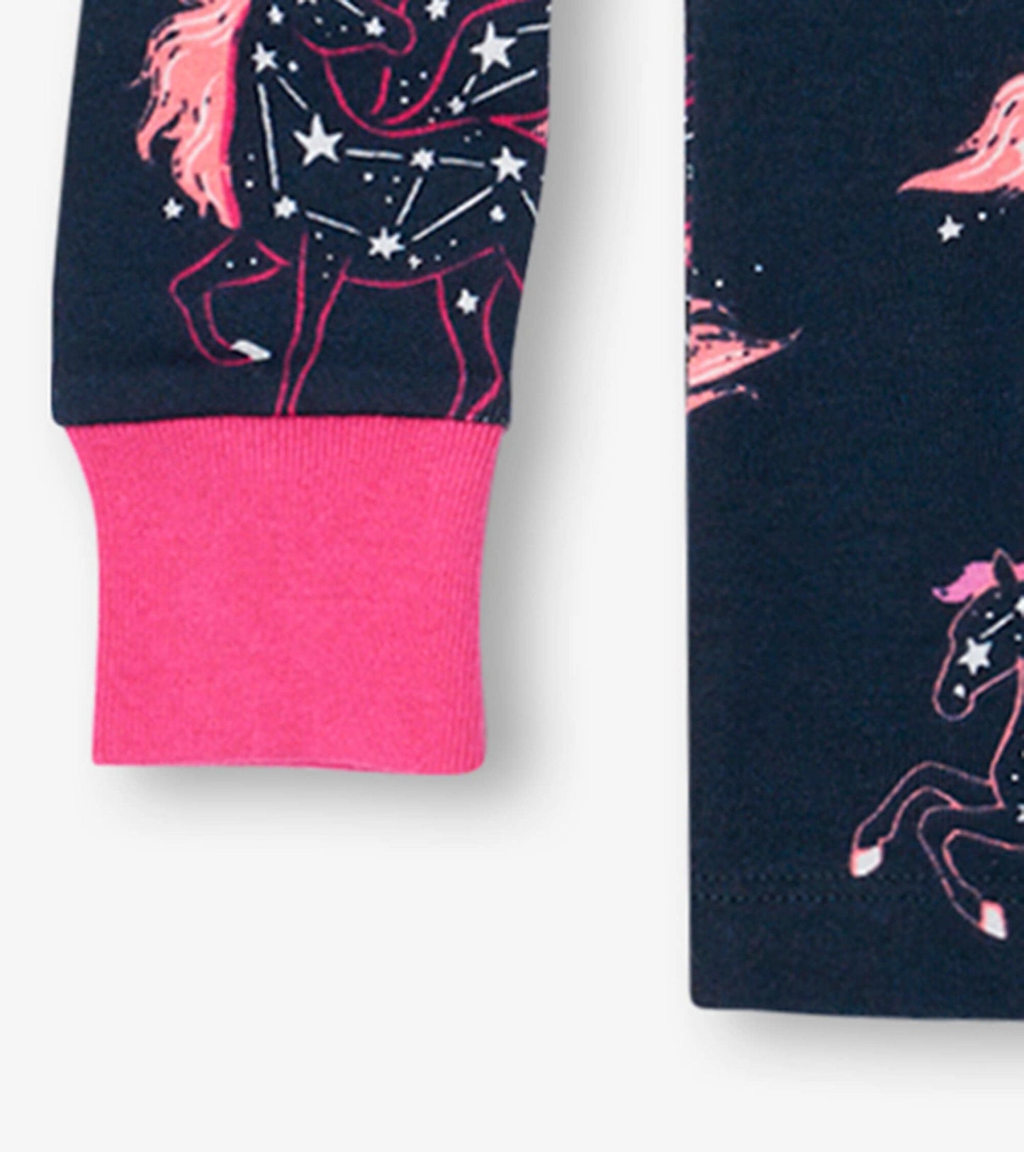 Navy organic cotton pyjama set featuring unicorn constellations and pink cuffs, ideal for kids' sleepwear.
