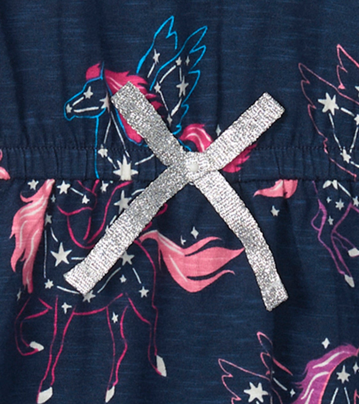 Navy drop waist dress featuring colorful pegasus and star print, with a silver ribbon detail at the waist.
