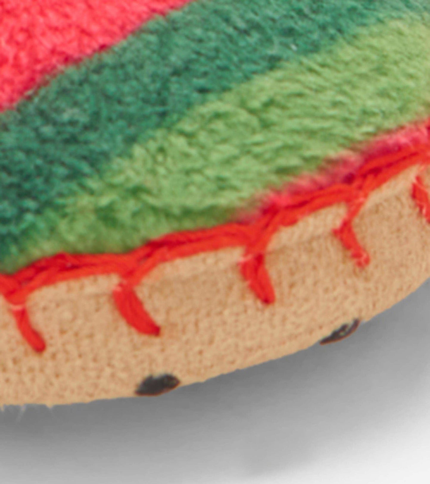 Red and green fleece kids' slippers with candy cane stripes and a soft, textured sole.
