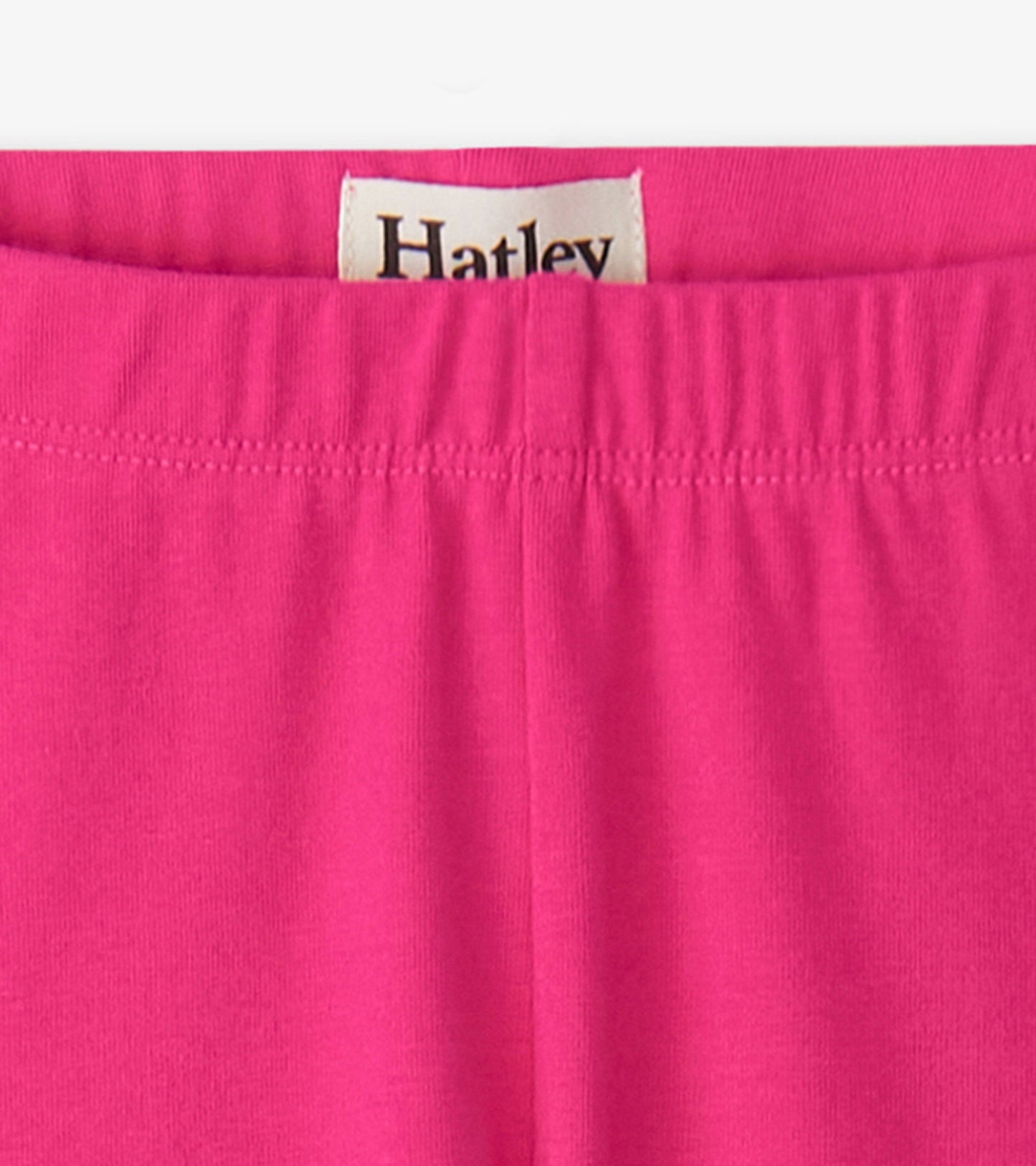 Fuschia bike shorts with an elastic waistband, made from soft, stretchy material, suitable for active wear.