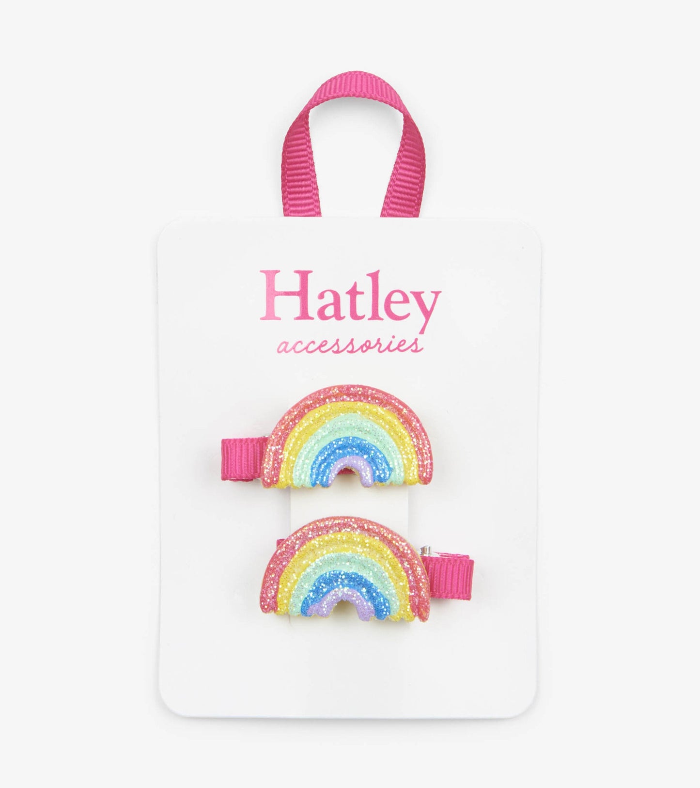 Two glittery rainbow hair clips with pink bands, displayed on a white card.