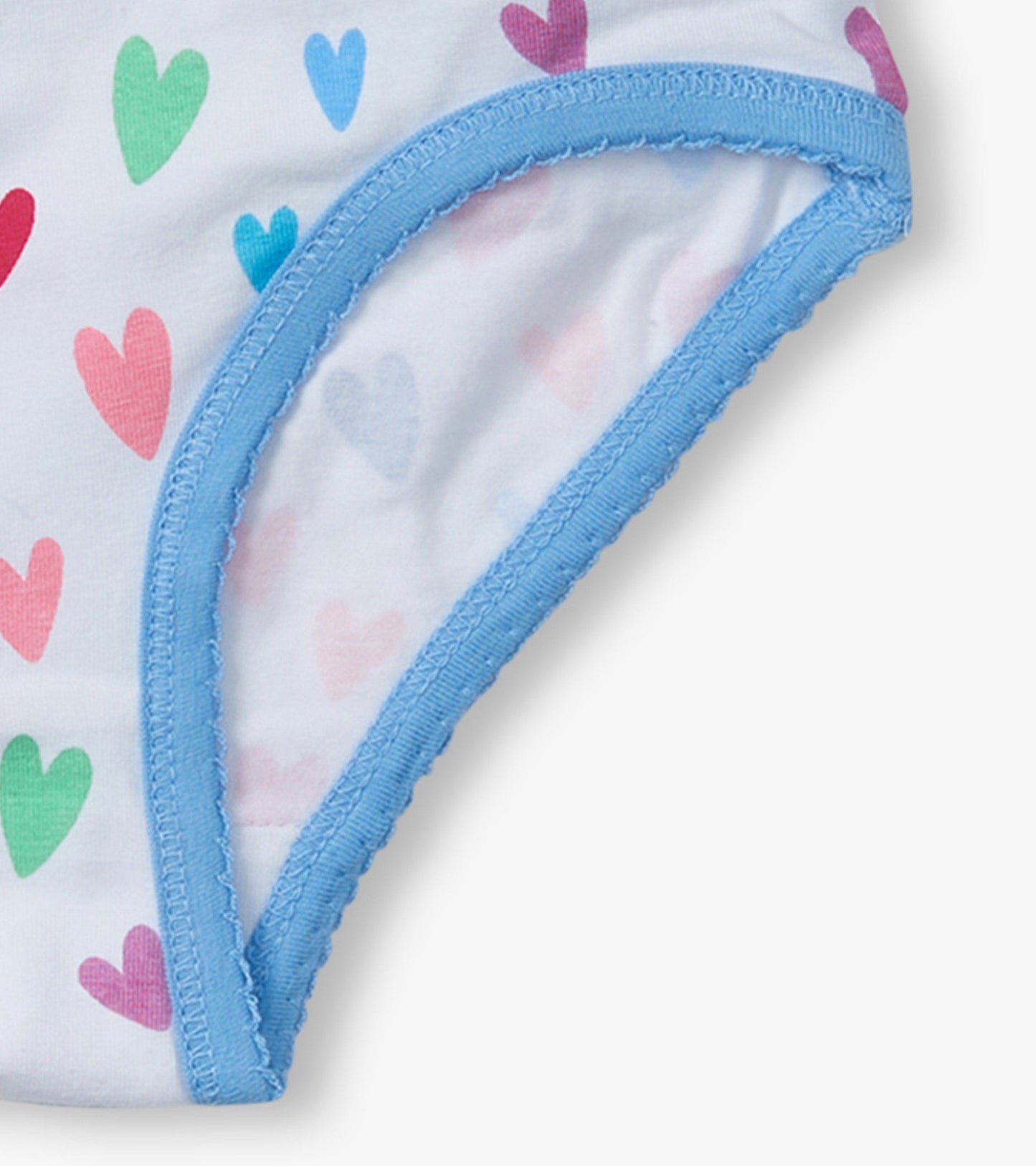 White brief underwear with colorful heart patterns and blue trim. Soft fabric suitable for girls.