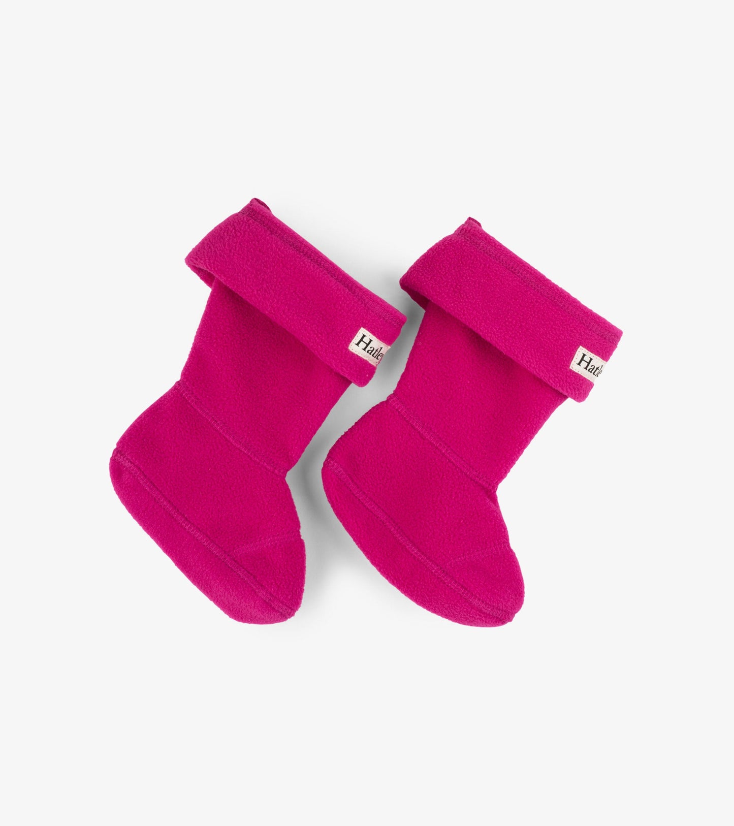 Magenta fleece boot liners with a fold-over cuff, designed for kids' footwear.