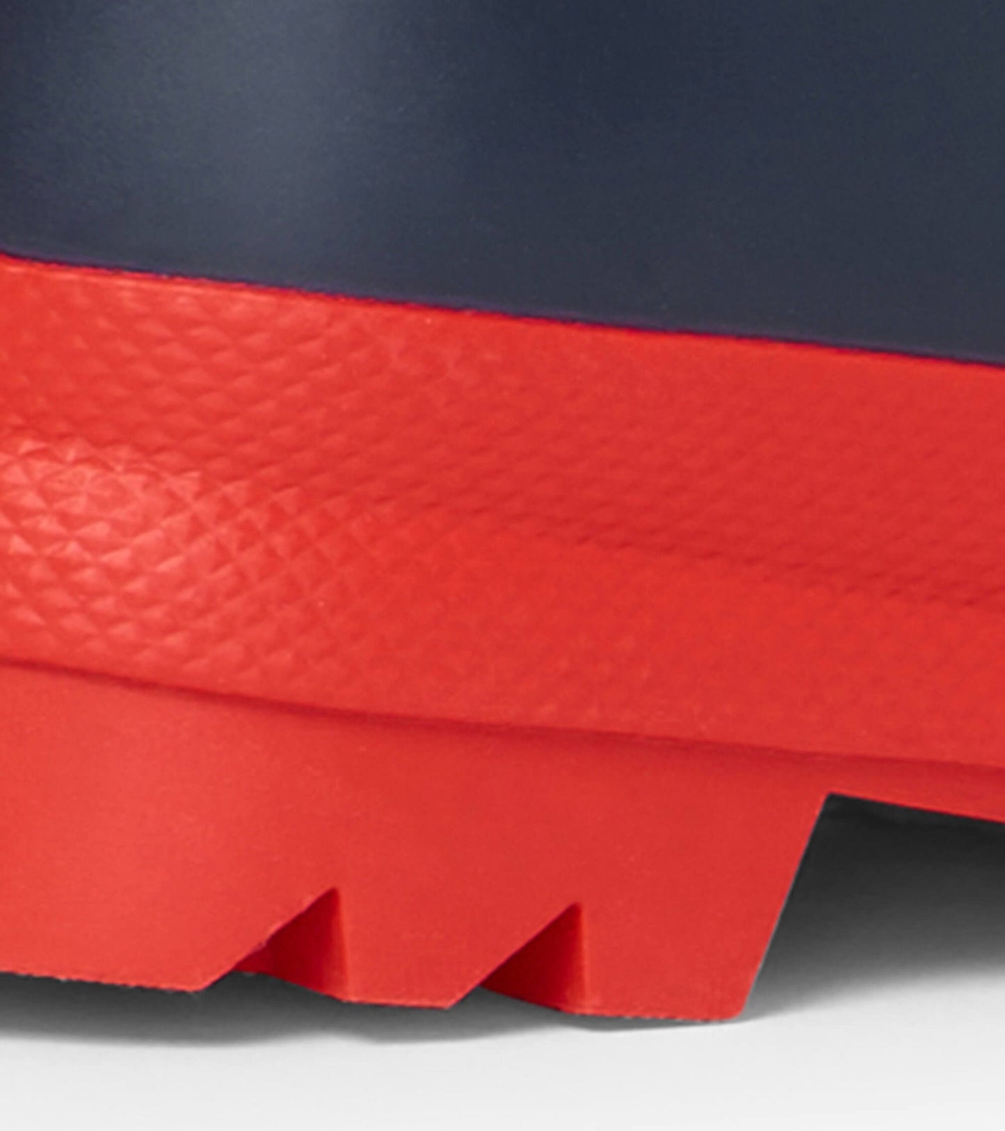 Navy and red matte wellies with a textured red sole, designed for kids, ideal for wet weather.