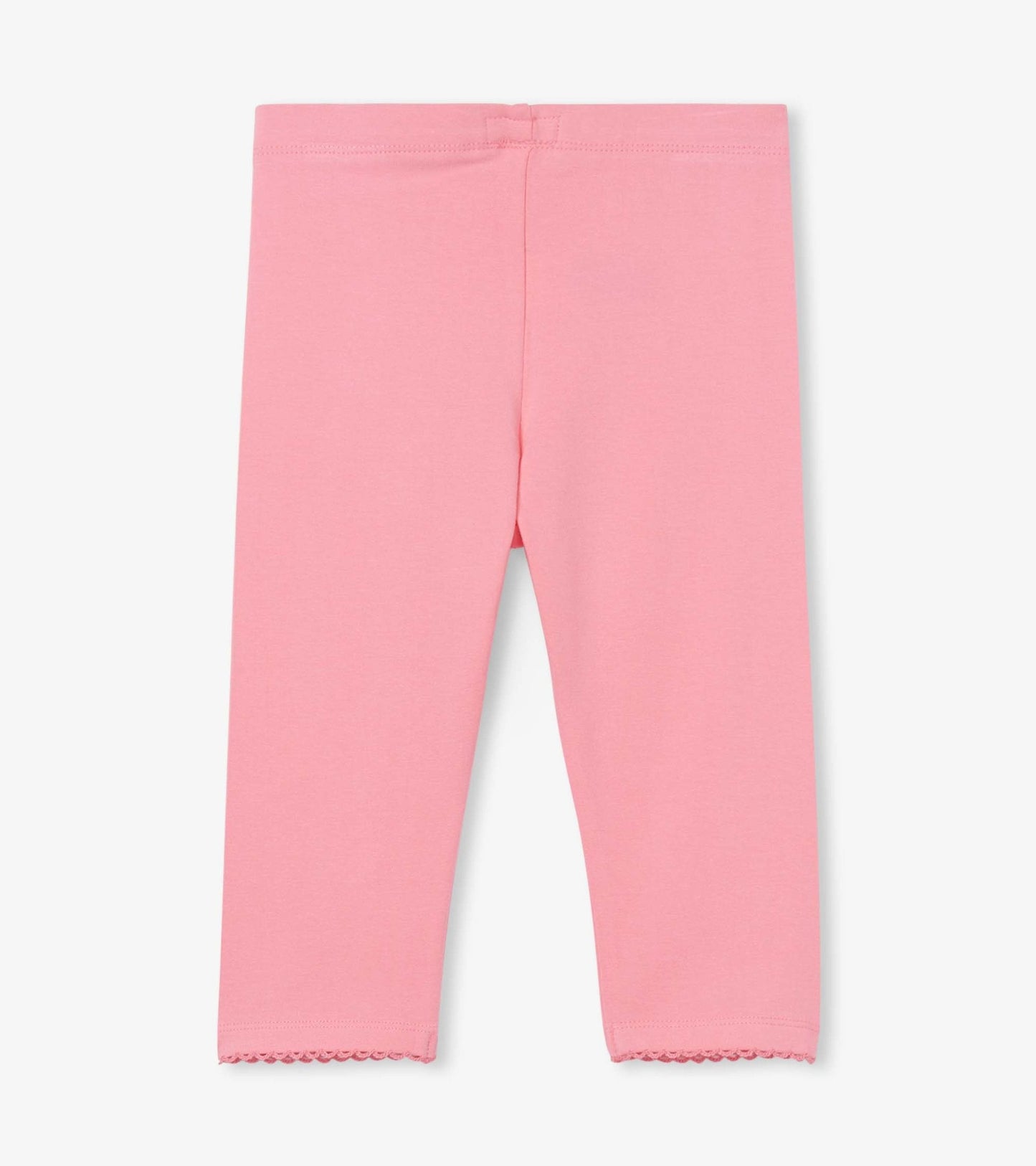 Light pink leggings with a fitted shape and scalloped hem, suitable for casual wear.