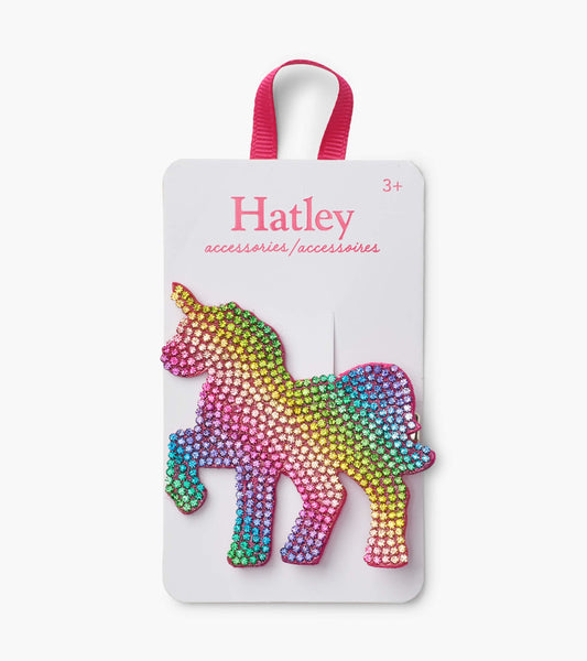 Colorful rhinestone unicorn hair clip with a shiny finish, attached to a card with a pink ribbon.