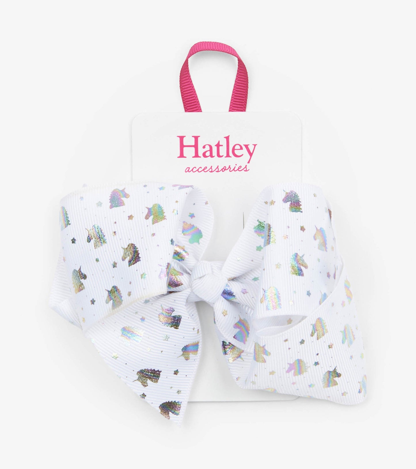 White bow hair clip featuring metallic unicorn and star patterns, secured with a central knot.