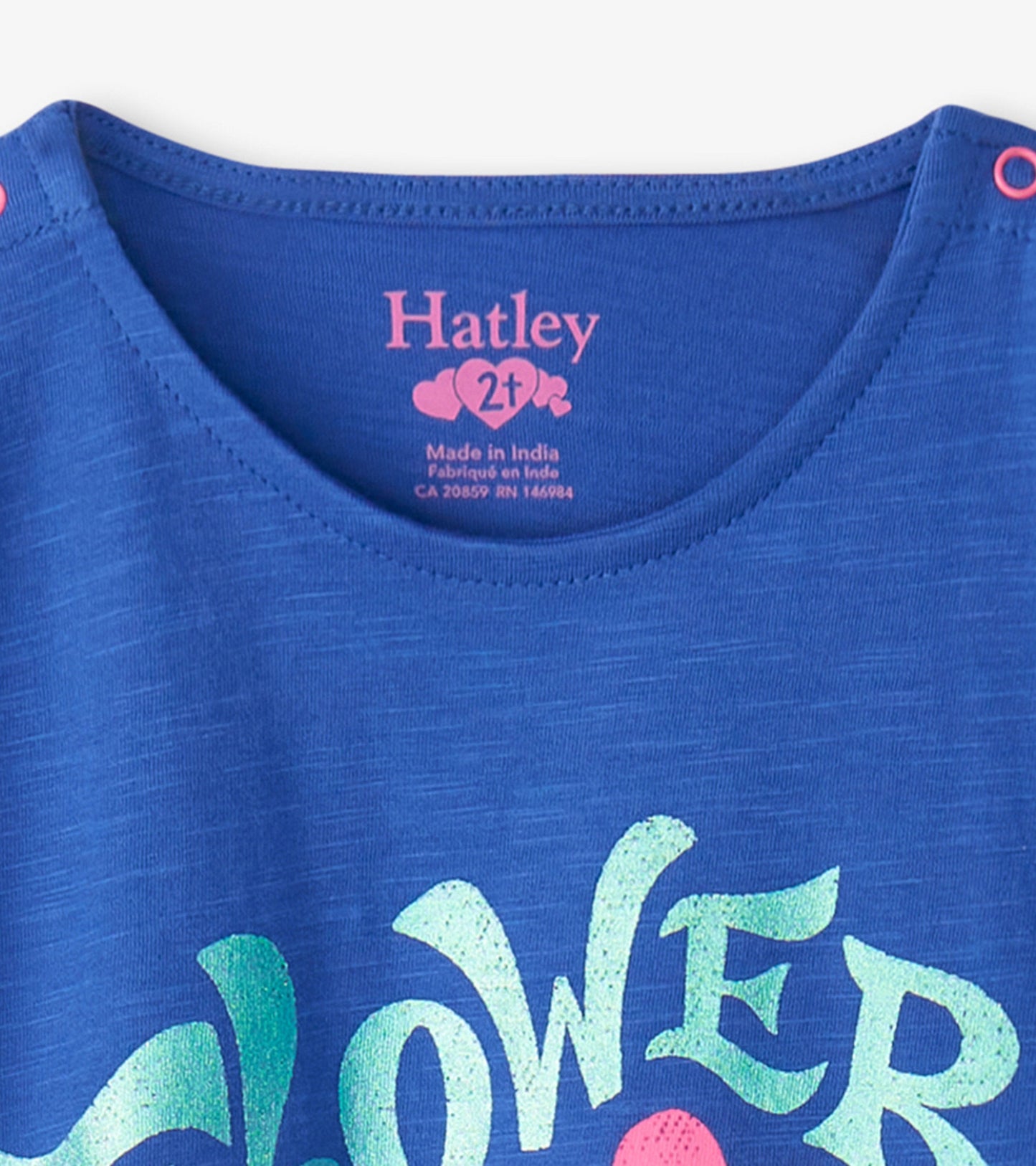 Blue short-sleeve shirt with a colorful "Flower Power" graphic and snap button closure at the shoulder.