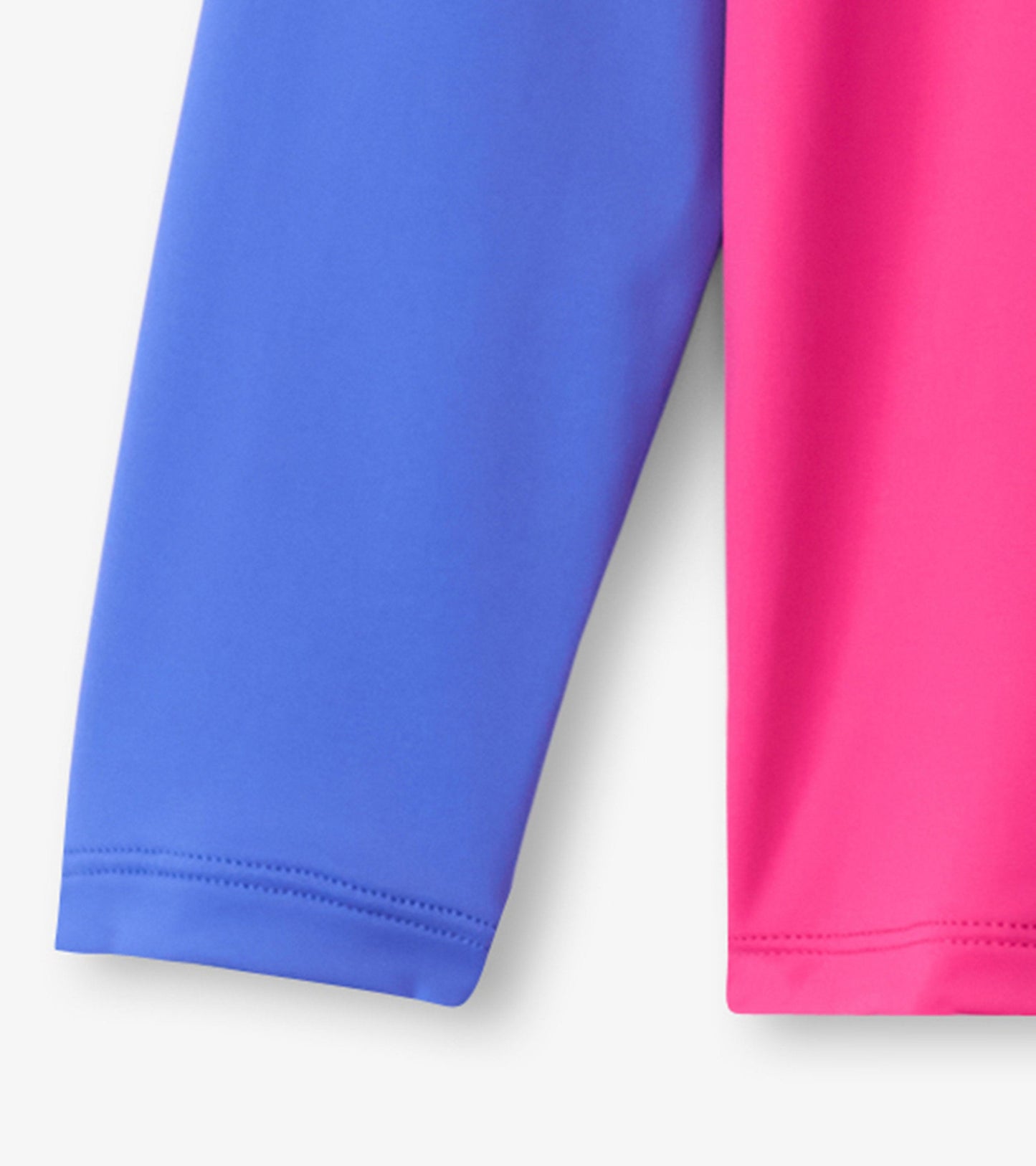 Fuschia purple long sleeve rashguard with contrasting blue sleeves, made from lightweight, stretchy material.