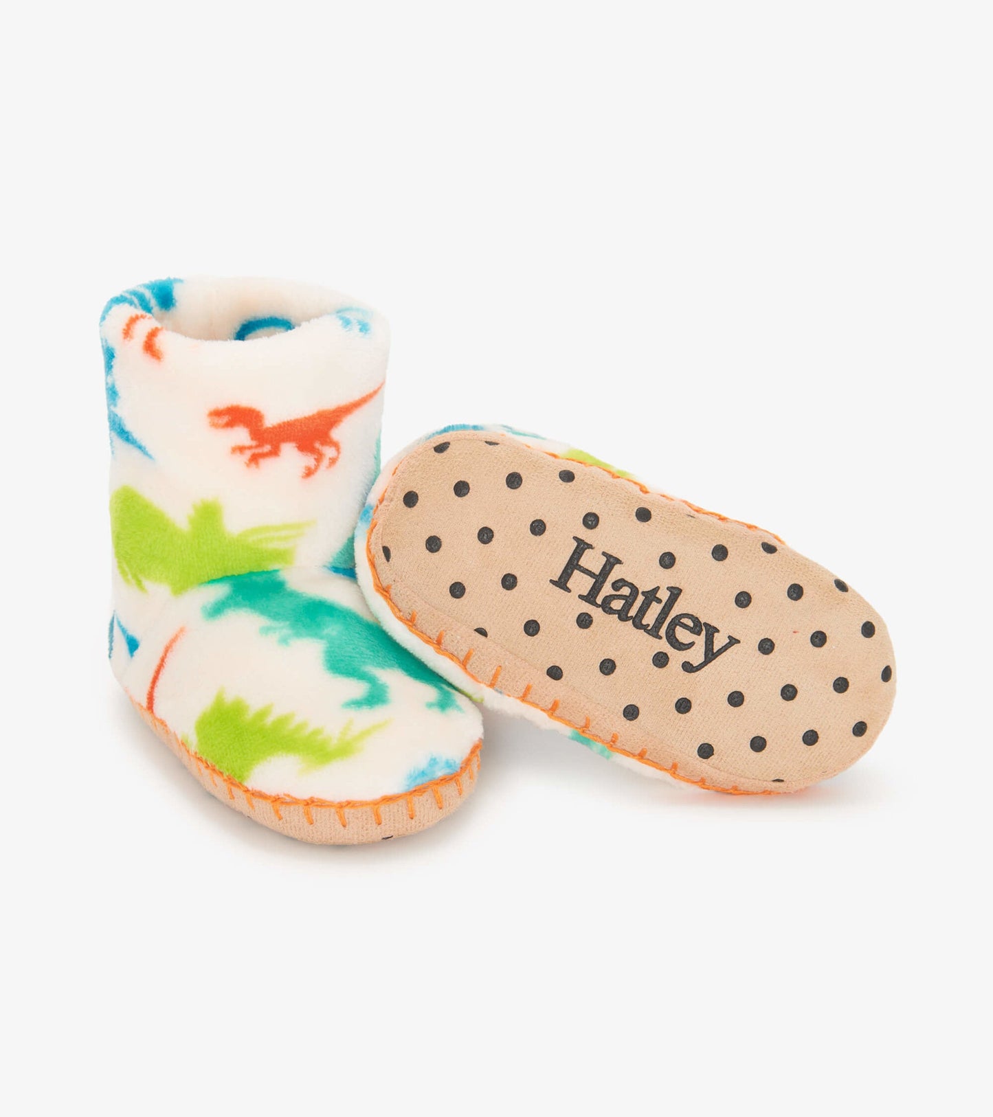 Colorful fleece slippers featuring dinosaur patterns, with a soft interior and dotted rubber sole for grip.