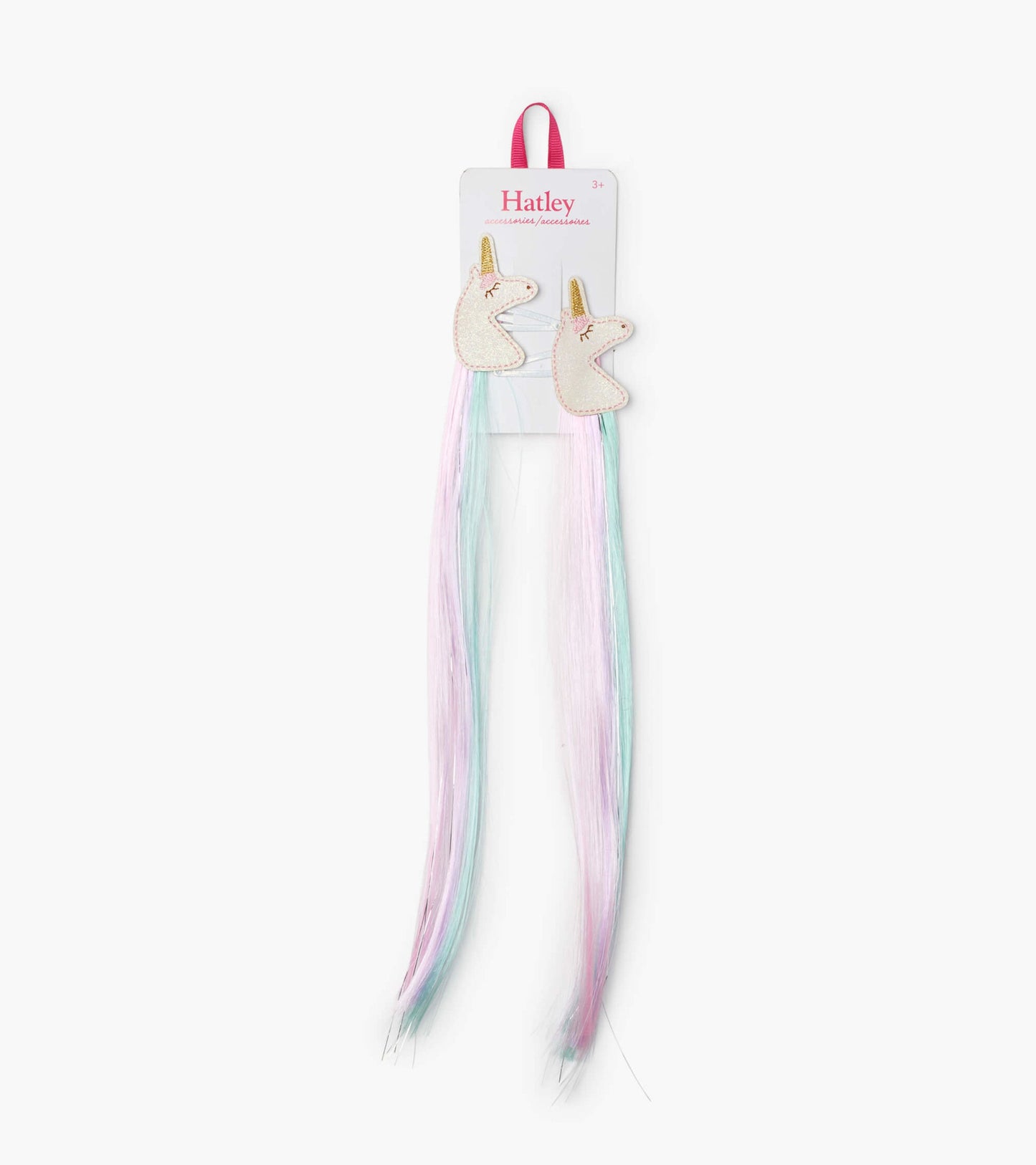 Two unicorn-shaped hair clips with pastel pink and blue faux hair extensions.