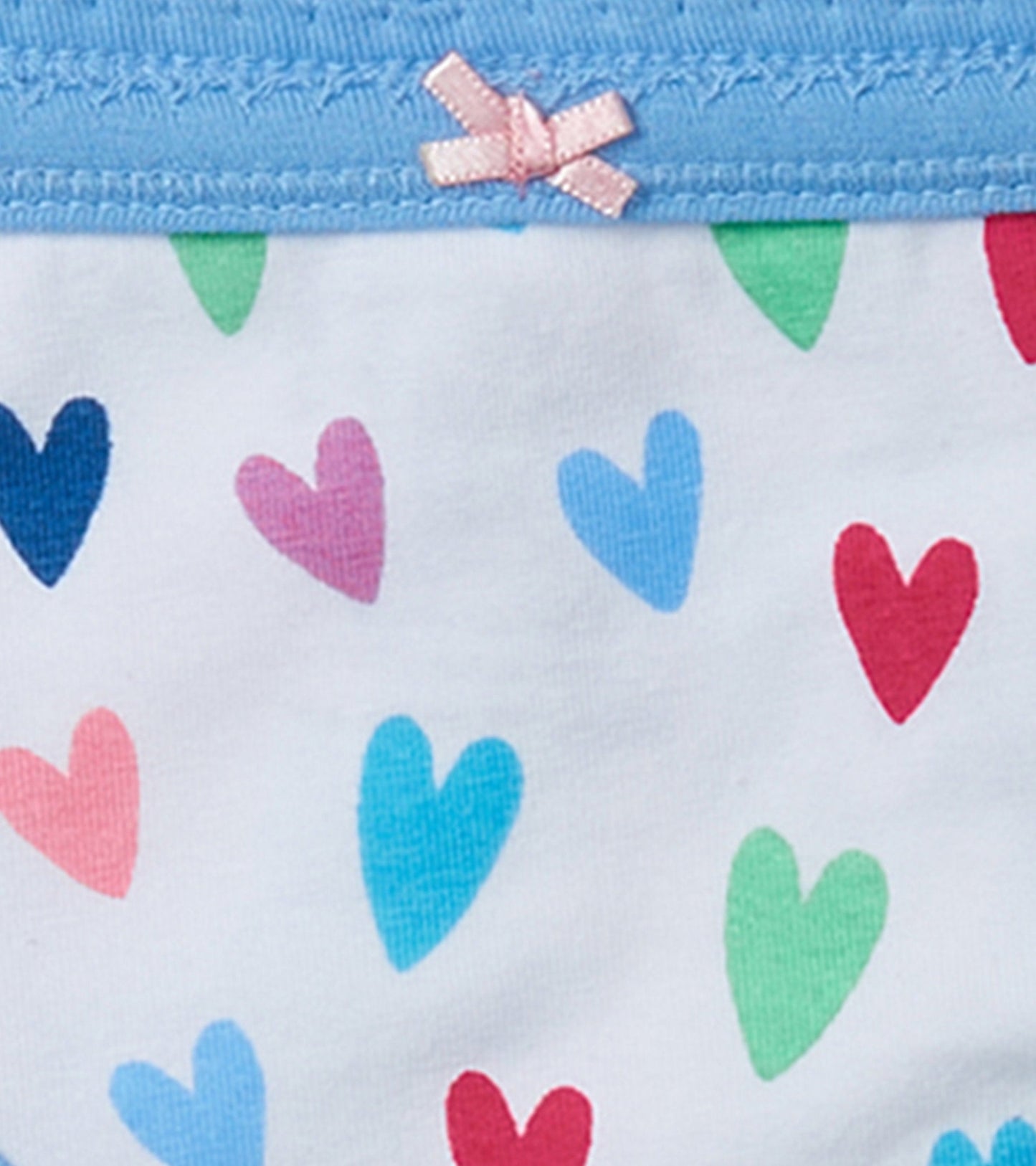 Girls' brief underwear featuring a light blue waistband and colorful heart patterns on a white background.