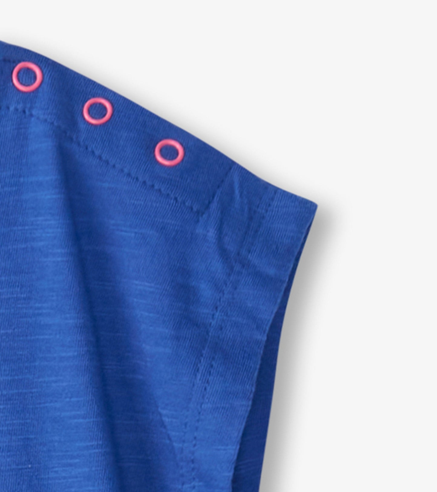 Blue snap button shirt for baby and toddler girls, featuring pink button accents and a soft, lightweight fabric.