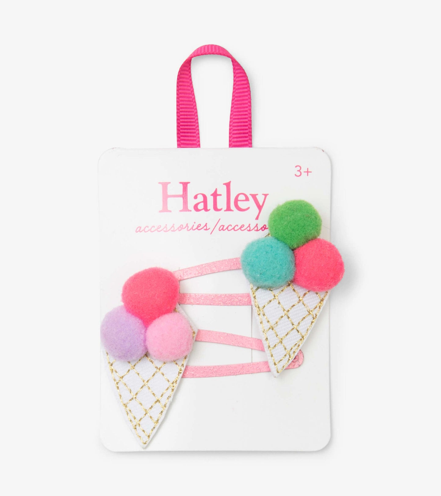 Colorful pom pom cone snap clips with pink, green, and purple felt balls on a white cone design, attached to a pink ribbon.