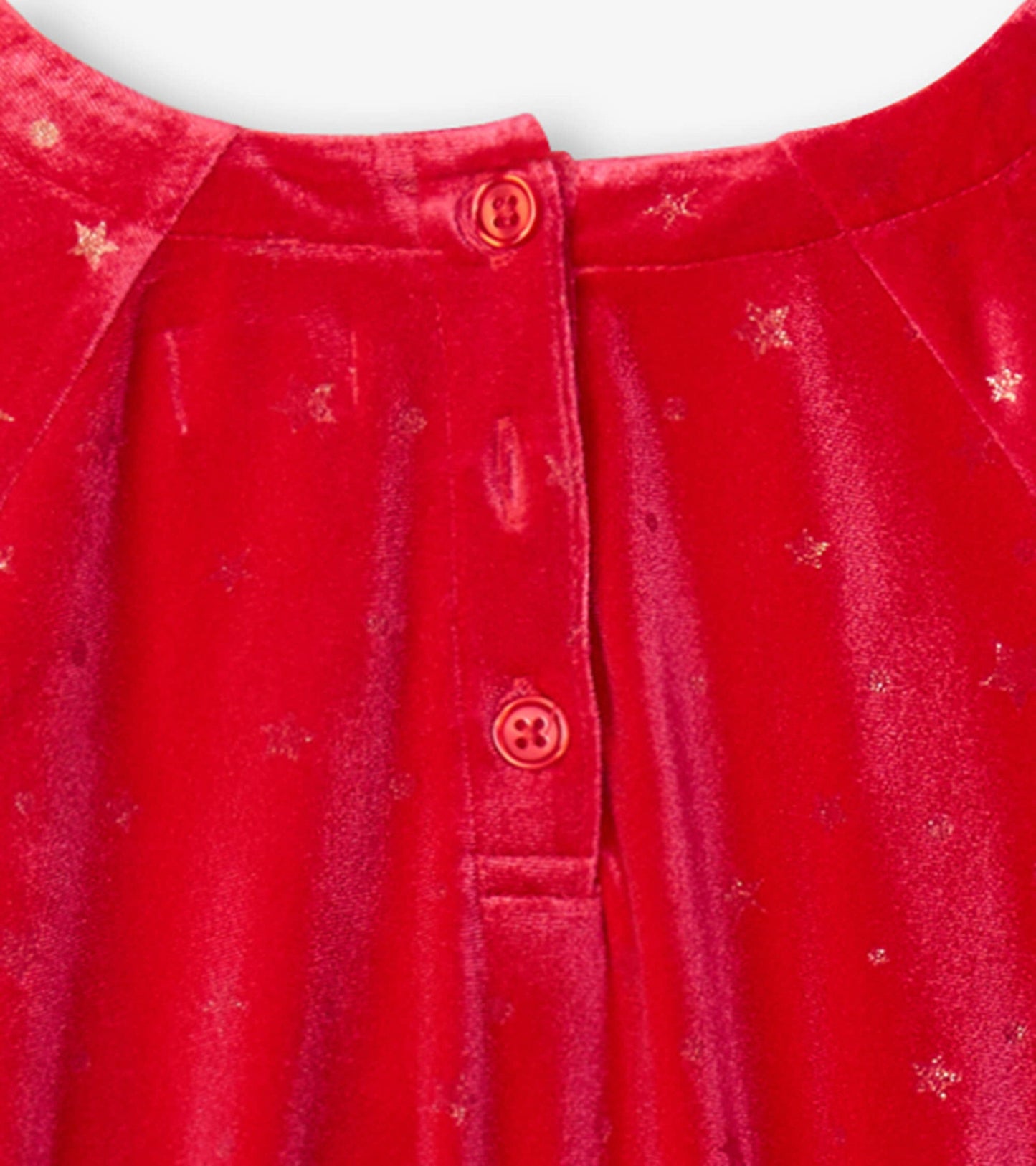 Red crushed velour dress featuring a star pattern and a button closure at the back. Suitable for holiday occasions.