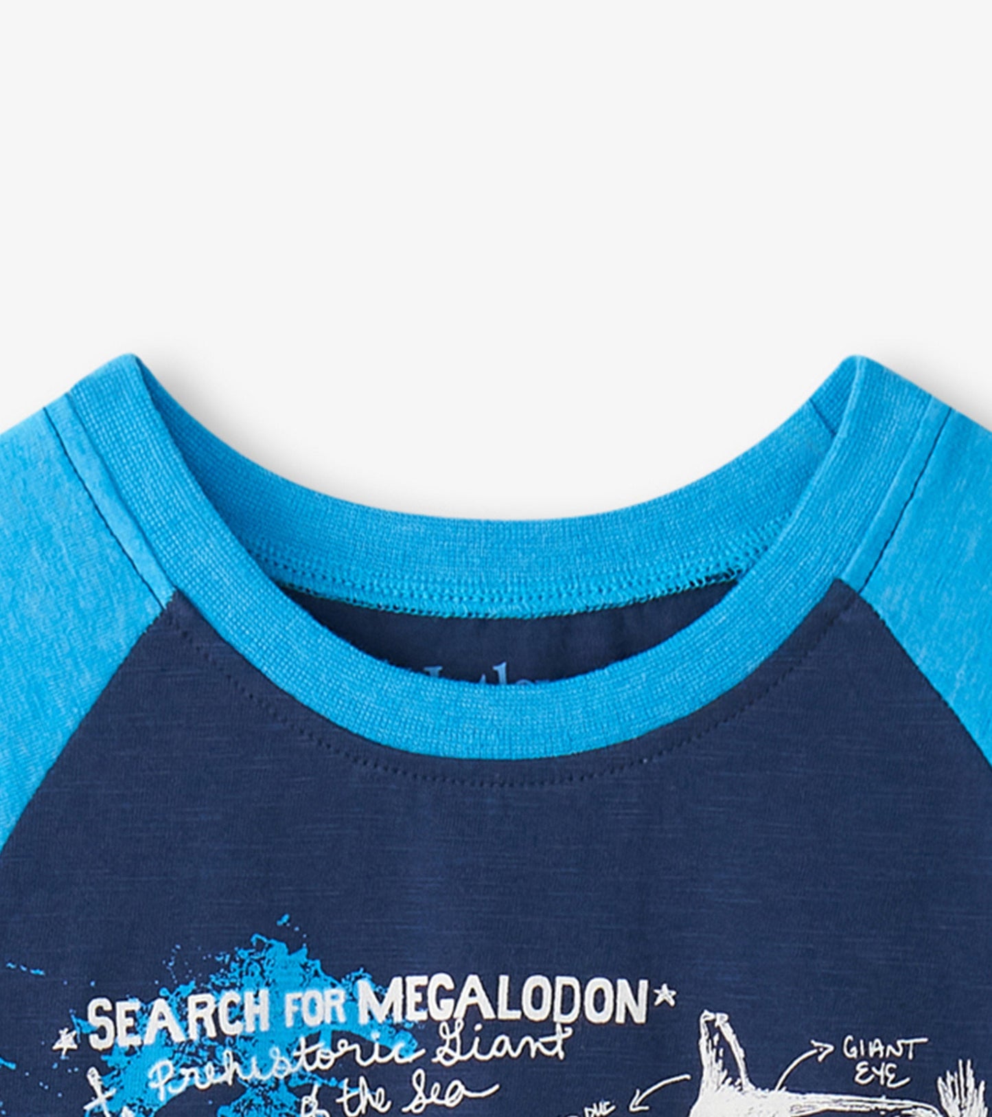 Blue and navy raglan t-shirt featuring a shark graphic and text, perfect for casual wear.