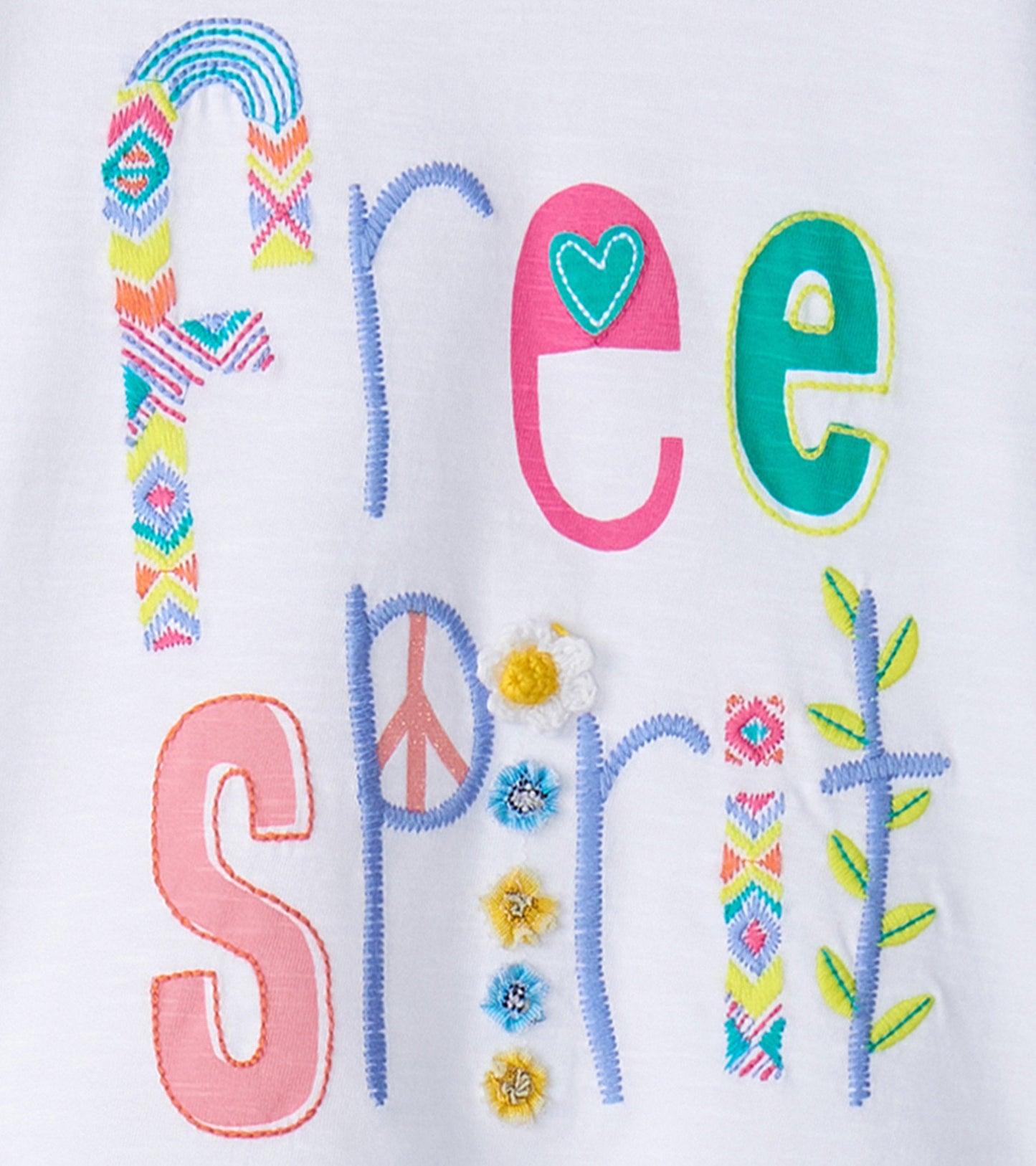 White graphic tee featuring colorful embroidered letters spelling "Free Spirit" with floral and peace symbols.