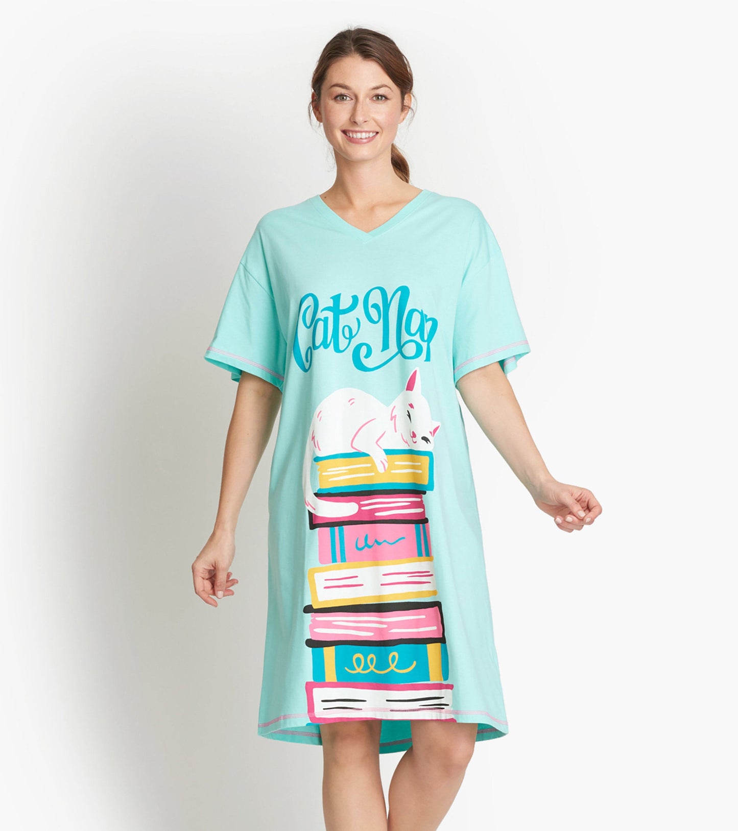 Light blue sleepshirt featuring a playful cat graphic resting on colorful stacked books, with a V-neck and short sleeves.