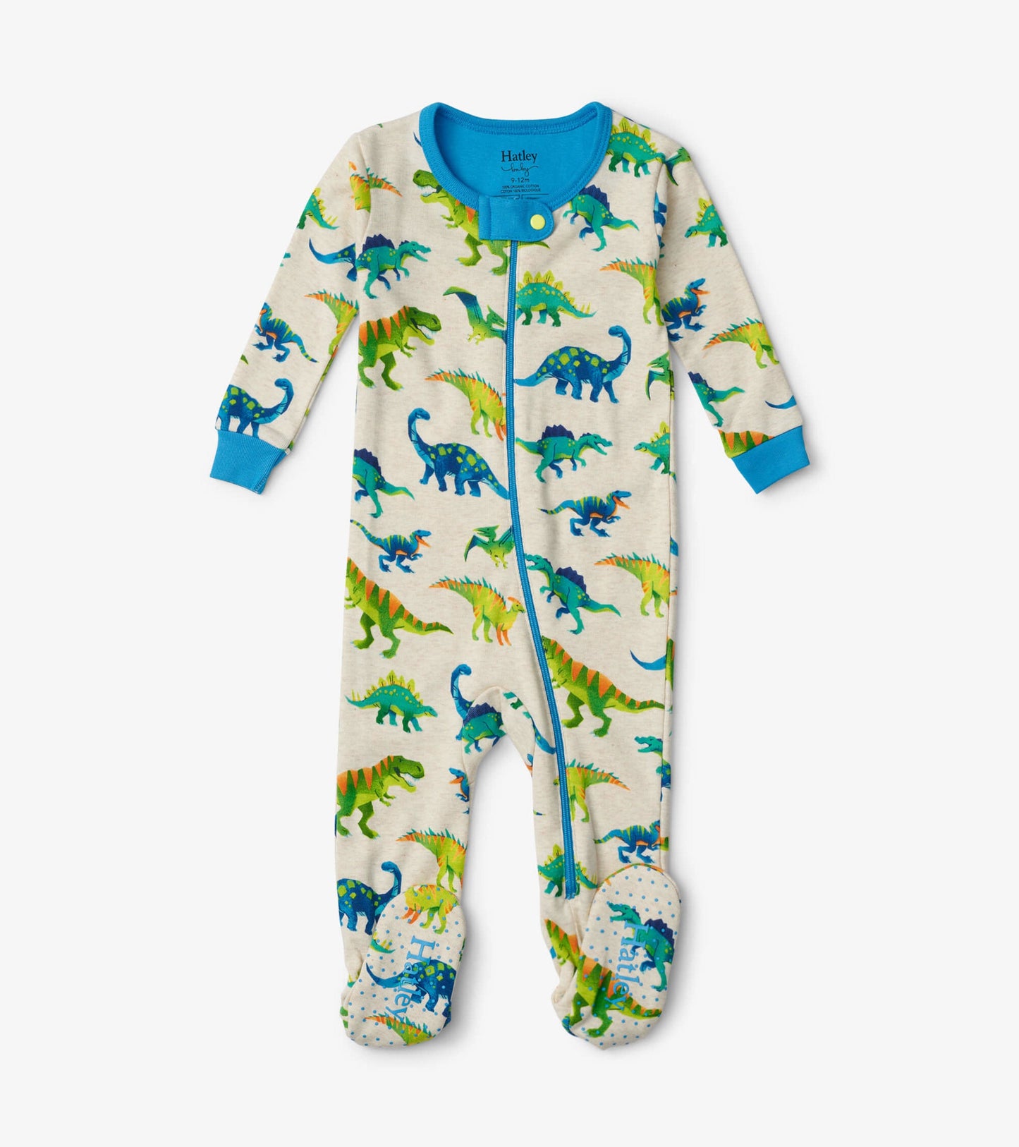Cream footed sleeper featuring colorful dinosaur prints and blue accents, suitable for infants.