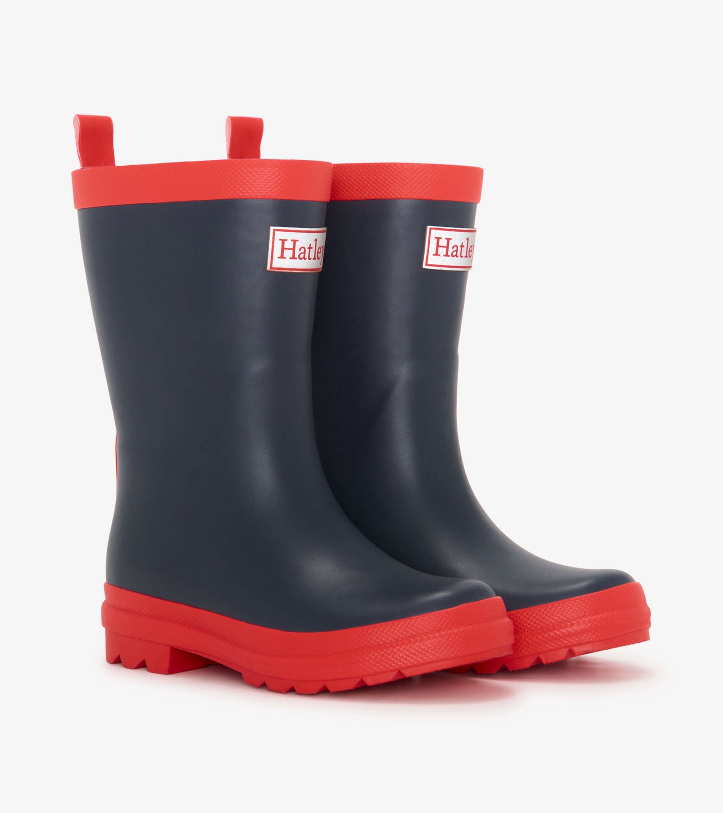 Navy and red matte wellies with a textured sole and pull tabs for easy wear, designed for kids.