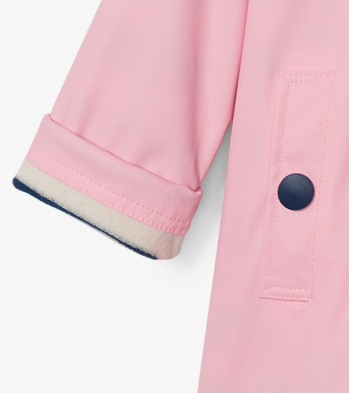 Pink button-up raincoat with navy trim and rolled sleeves, designed for girls.