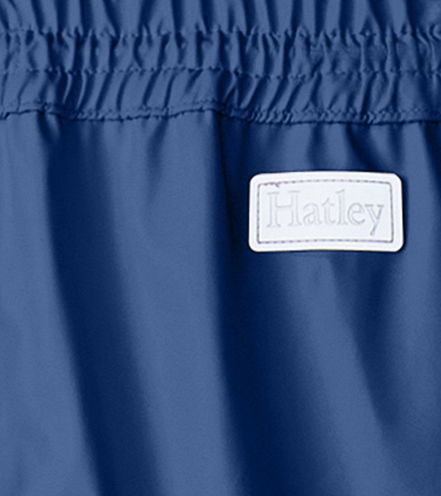 Classic navy rain pants with an elastic waistband, designed for kids, made from waterproof material.