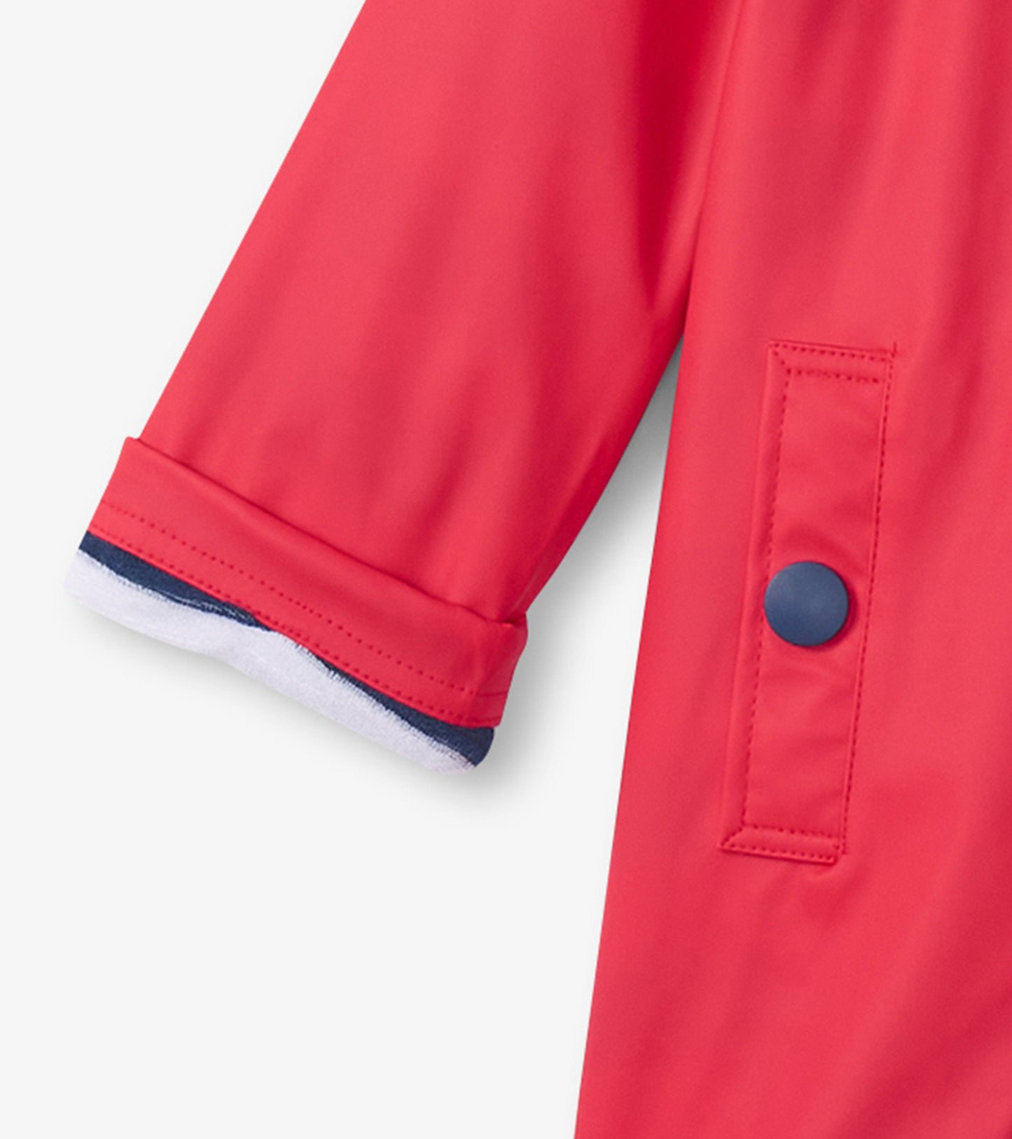 Red and navy button-up raincoat featuring a button closure and contrasting cuffs, designed for kids.