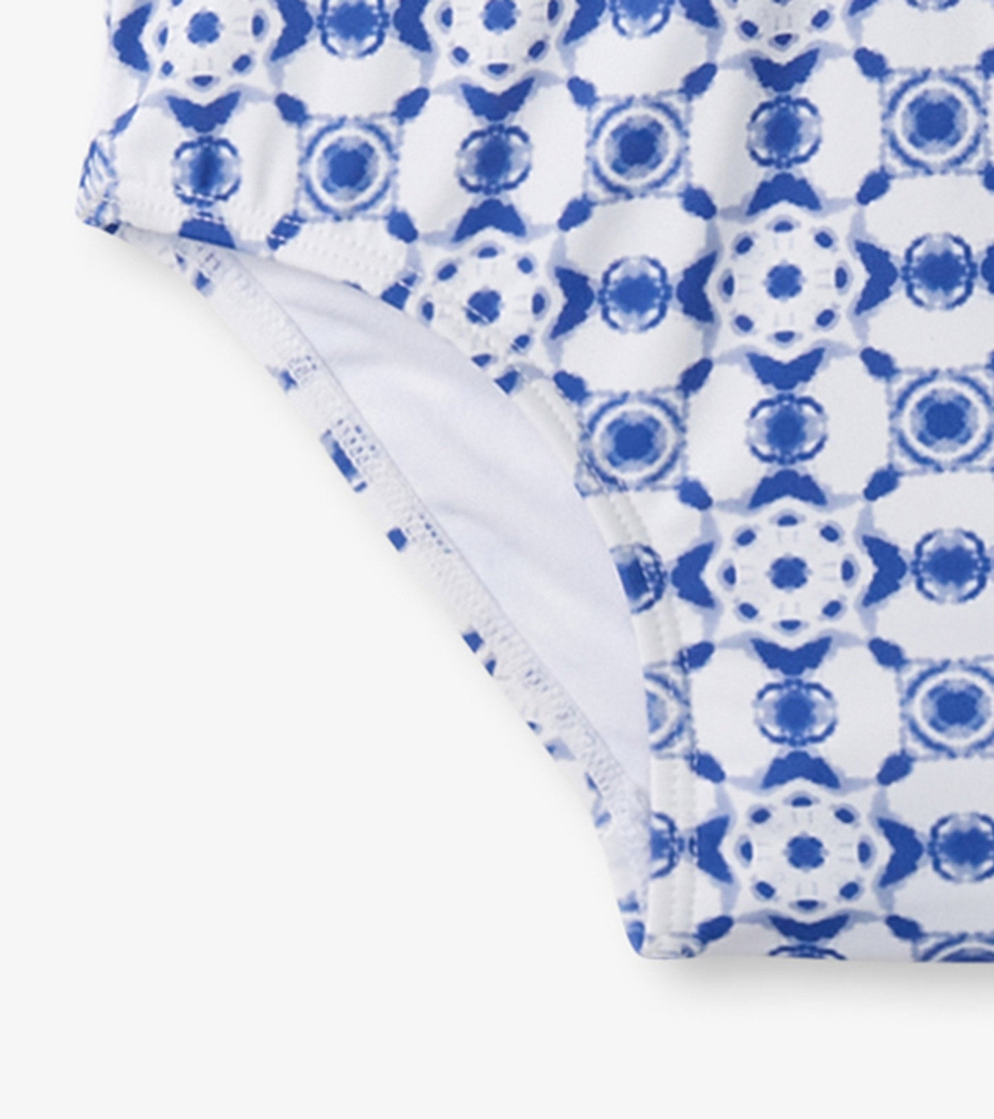 Blue and white kaleidoscope patterned one-piece rashguard for girls, featuring a snug fit and soft material.