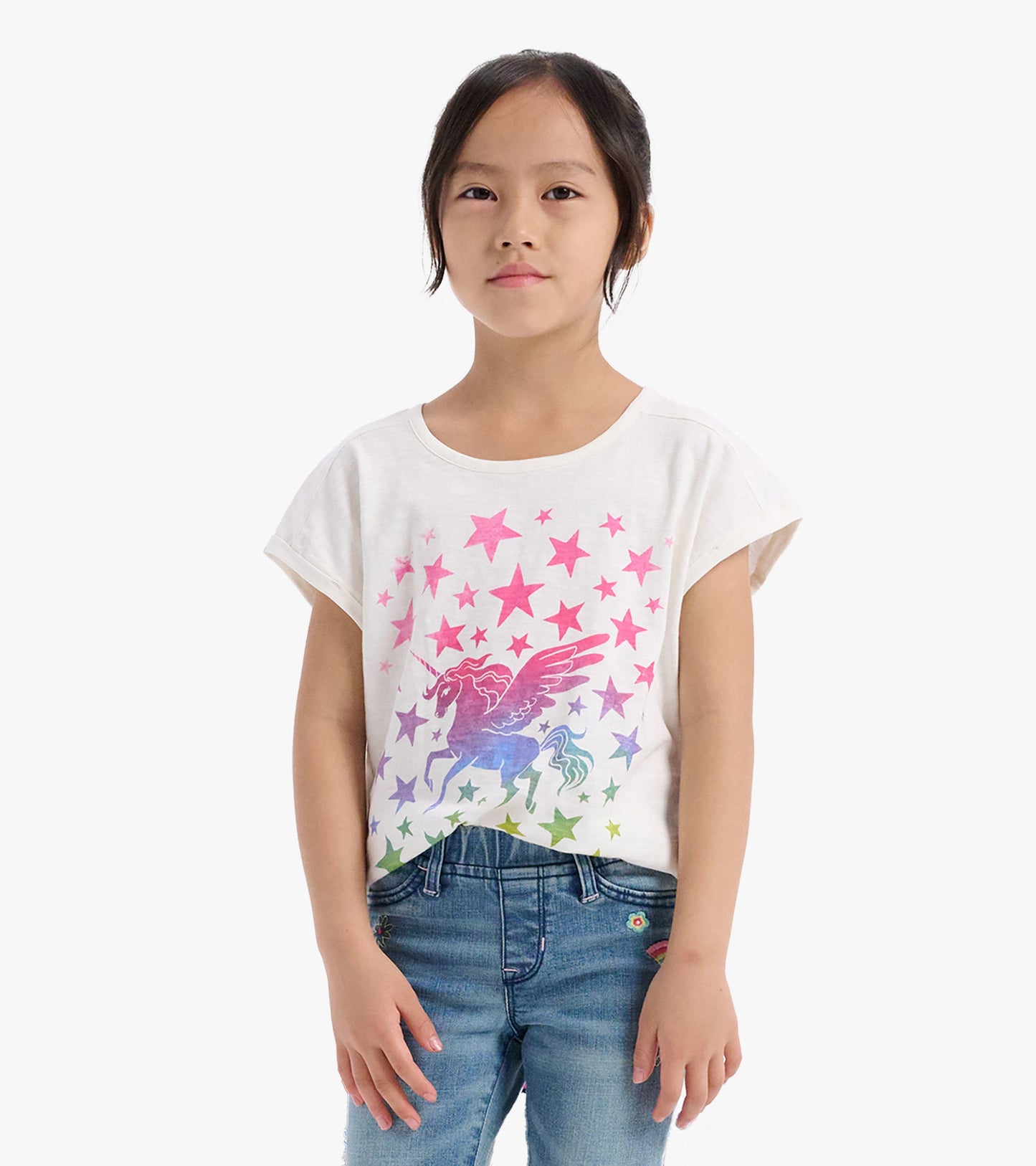 White relaxed t-shirt featuring a colorful unicorn and star graphic, suitable for girls.