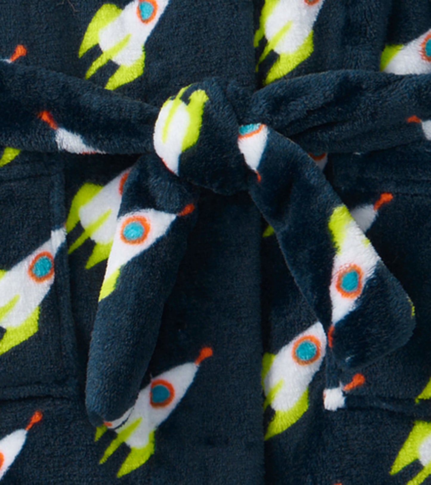 Navy fleece robe featuring colorful rocket patterns, tied at the waist with a soft belt. Ideal for kids.