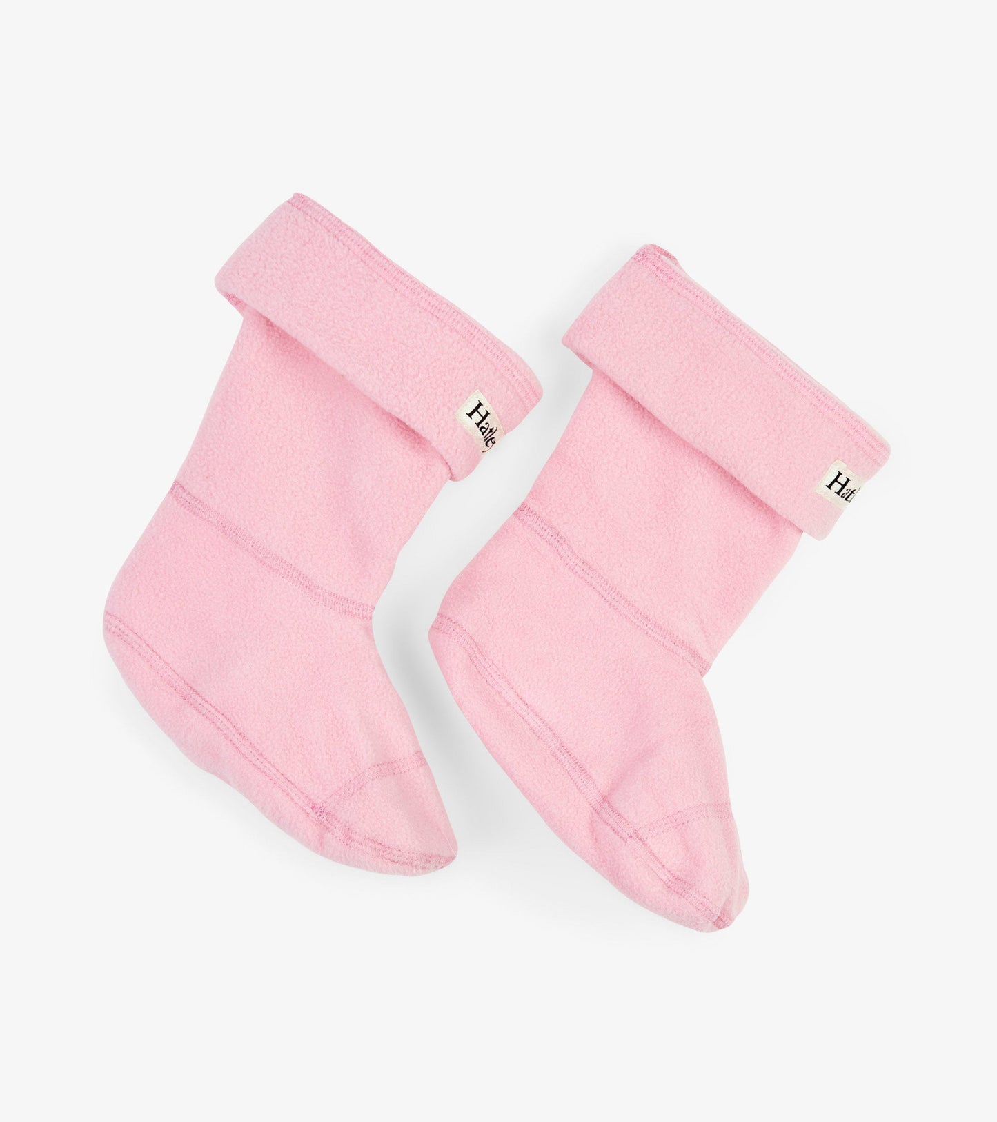 Pink fleece boot liners with a fold-over cuff, designed for kids in various sizes.