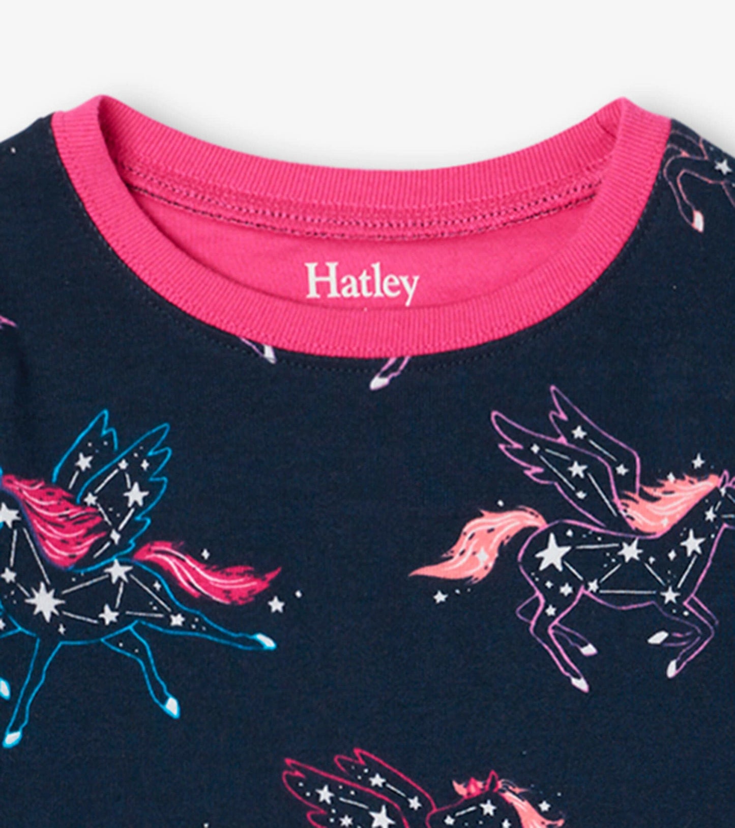 Navy organic cotton pyjama top with pink neckline, featuring colorful unicorn constellations and star patterns.