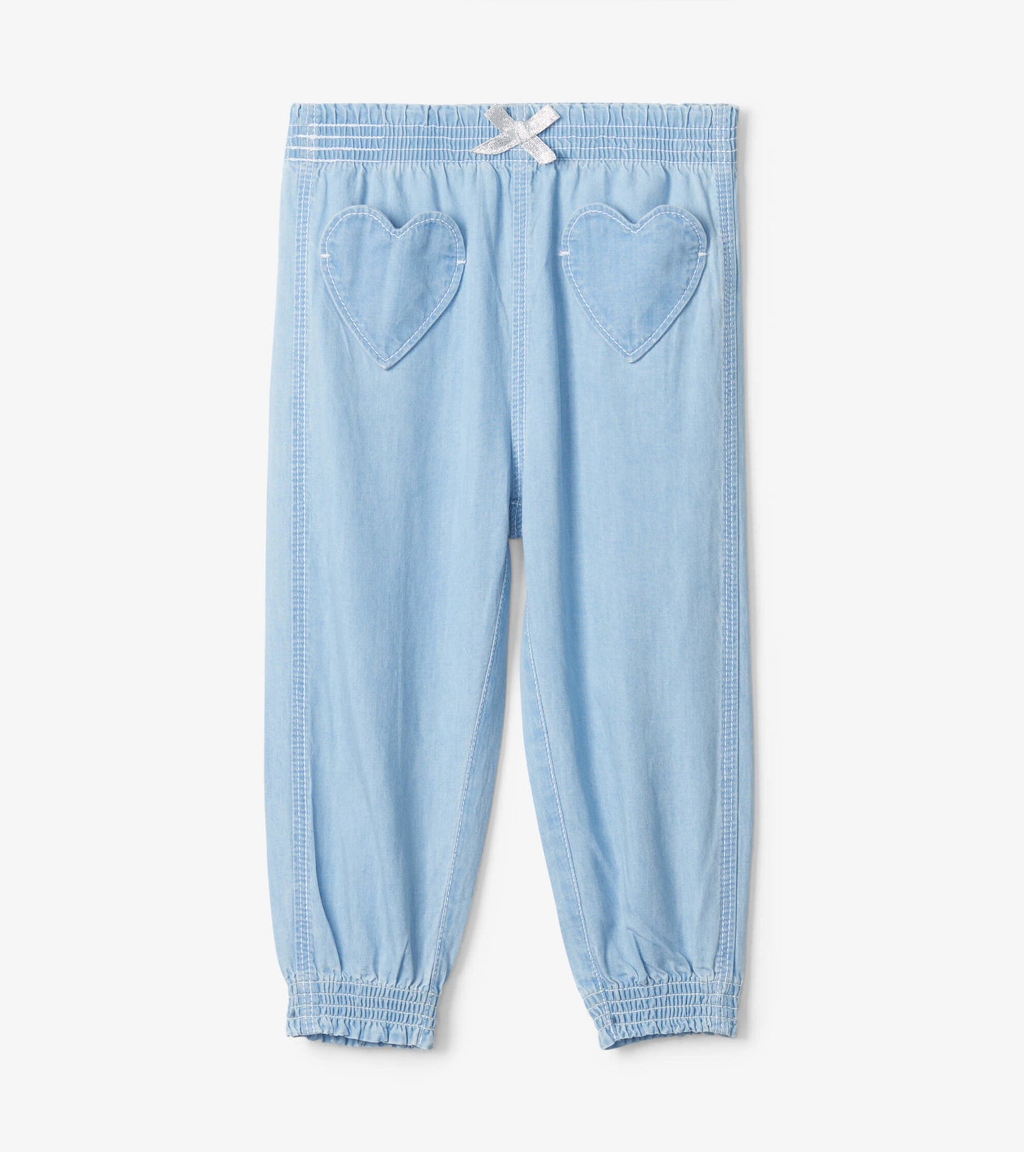 Light blue denim baggy pants with heart-shaped pockets and elastic cuffs, suitable for baby and toddler girls.