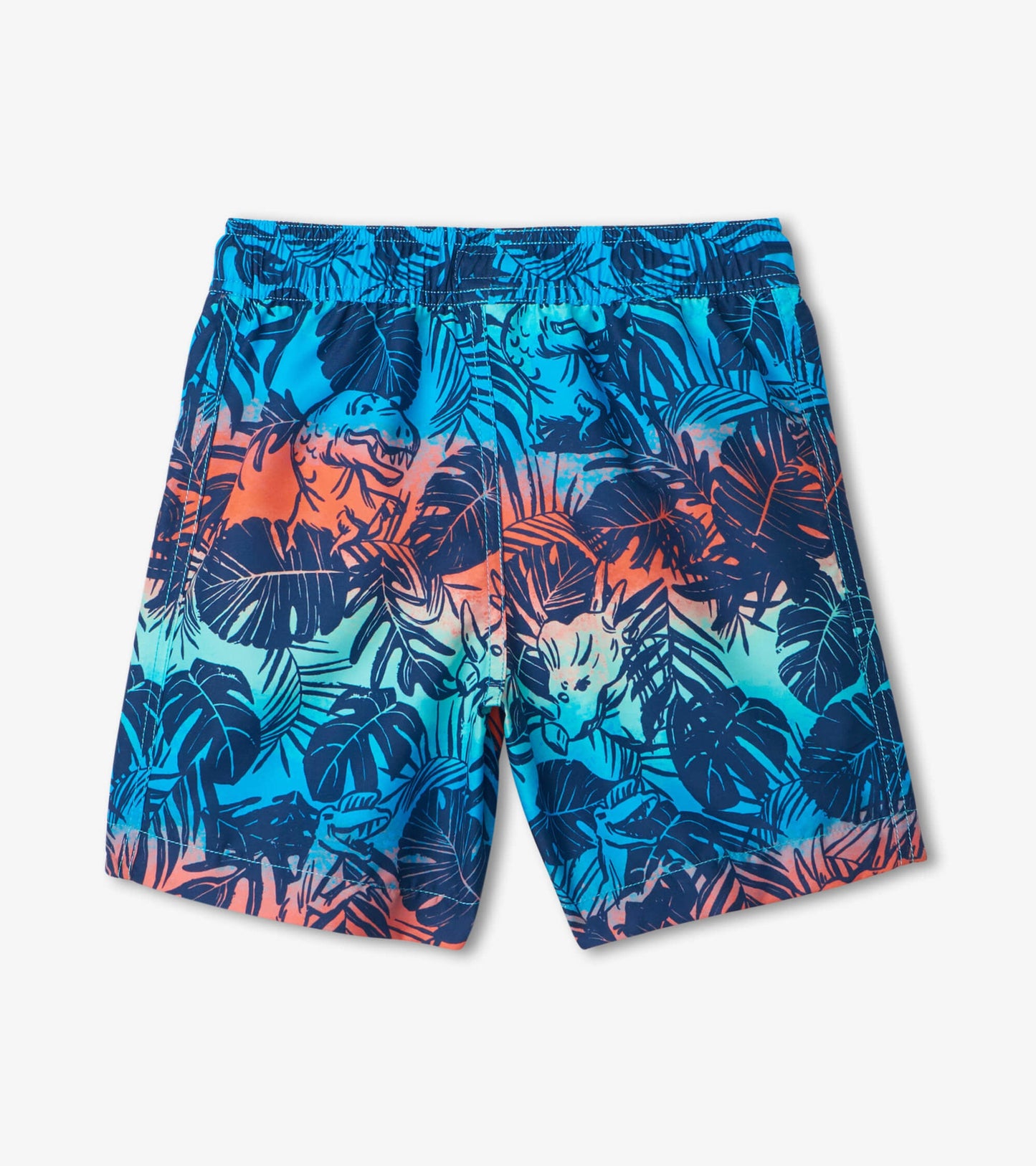 Colorful swim trunks featuring a dinosaur and tropical leaf pattern in blue, orange, and green hues.