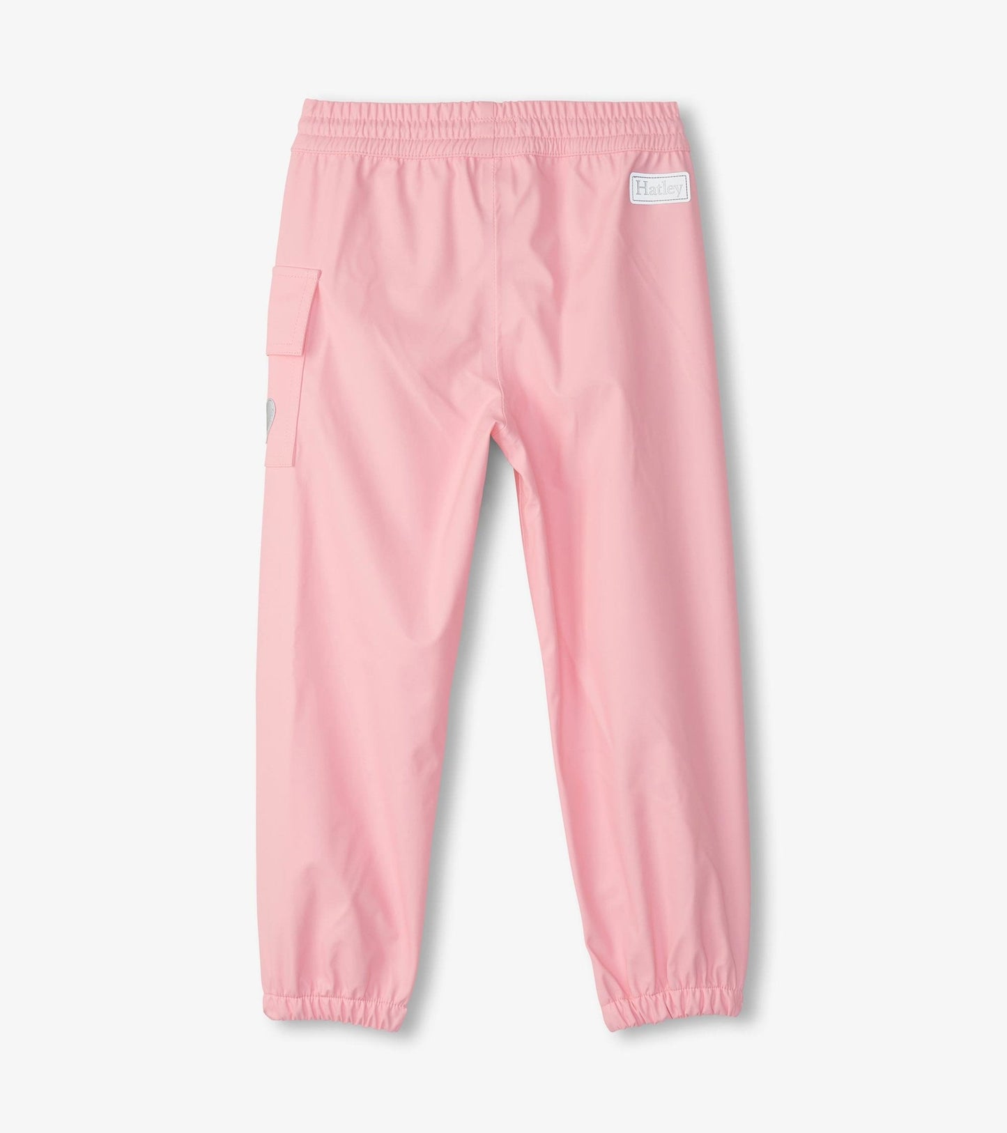 Light pink waterproof kids' rain pants with an elastic waistband and side pocket, suitable for outdoor play.