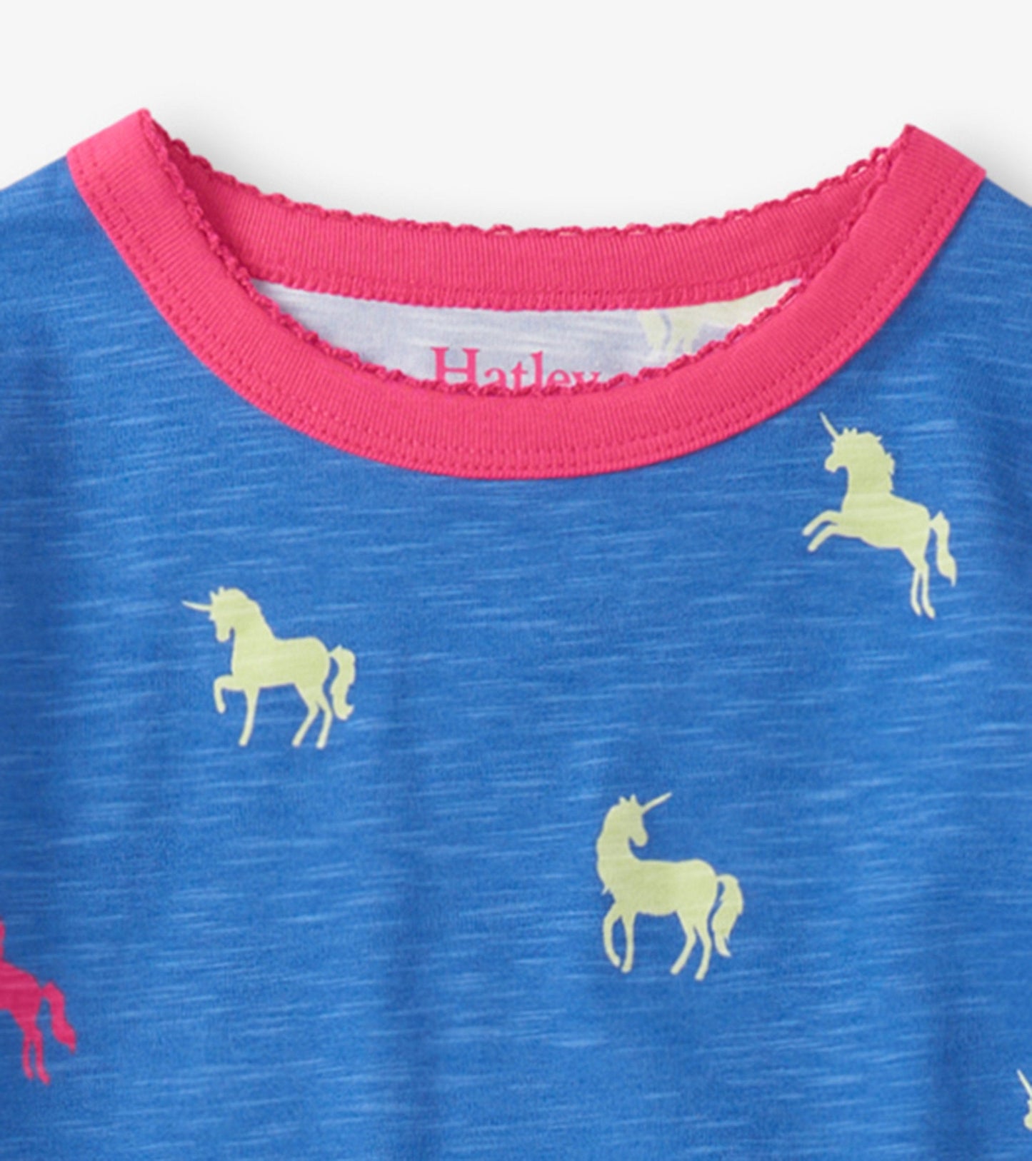 Blue pajama top with pink scalloped neckline, featuring yellow unicorn prints throughout.