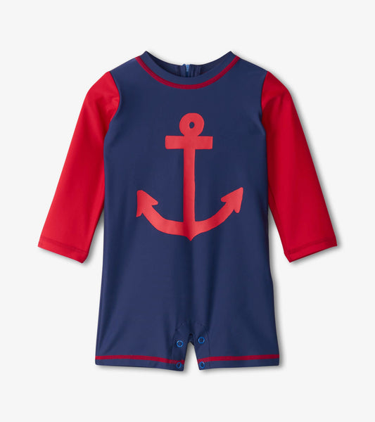 Navy one-piece rashguard with red sleeves and a large red anchor graphic, featuring snap closures at the bottom.