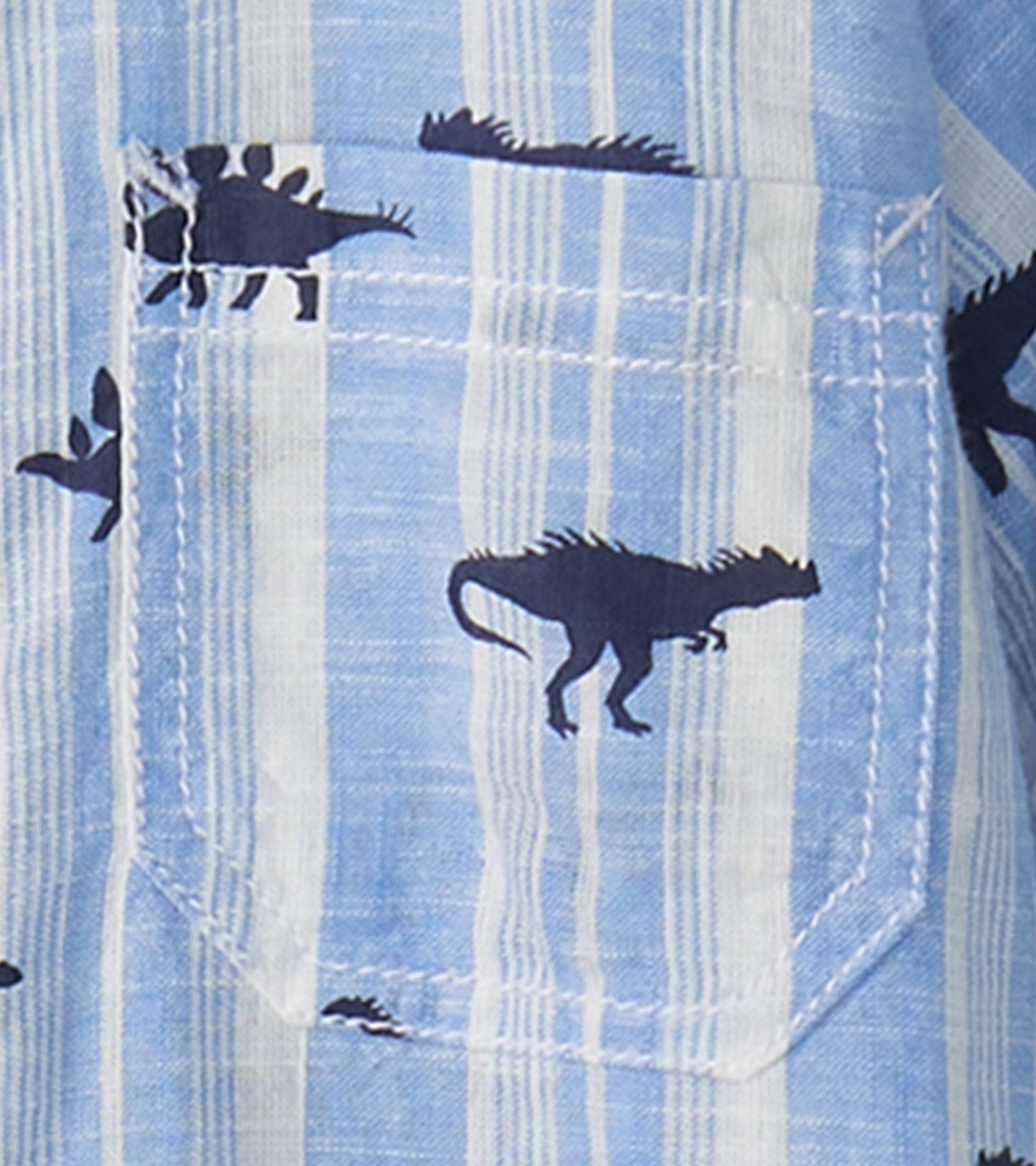 Light blue button-down shirt featuring dark dinosaur silhouettes and stripes, with a chest pocket detail.