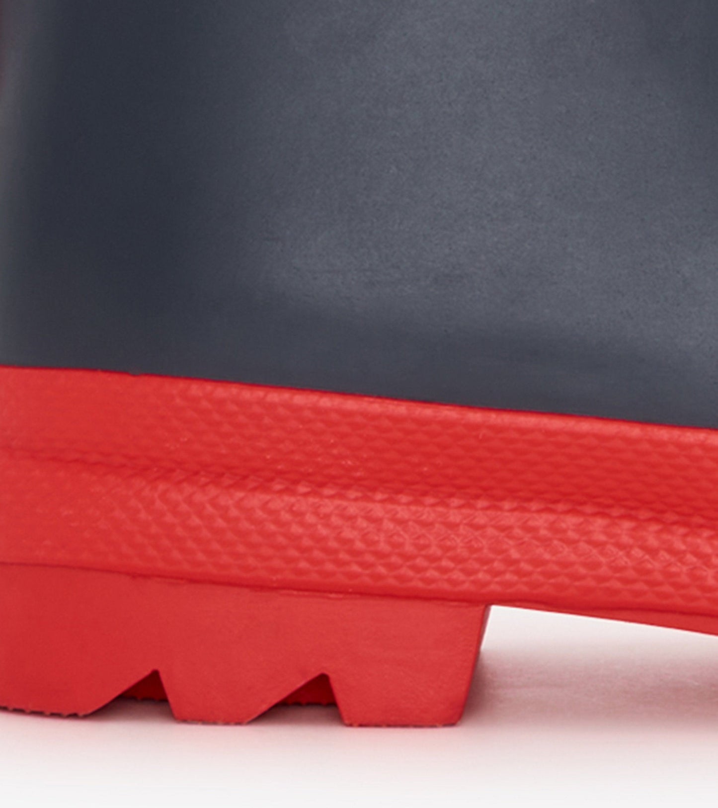 Navy matte wellies with a red sole, featuring a textured grip for kids, ideal for wet weather.