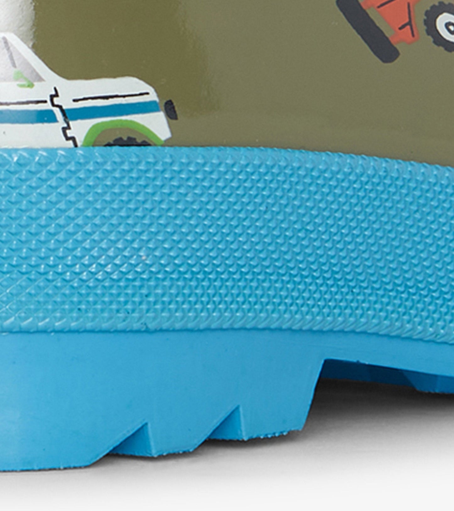 Green shiny wellies with a blue textured sole and off-roading vehicle patterns, suitable for kids.