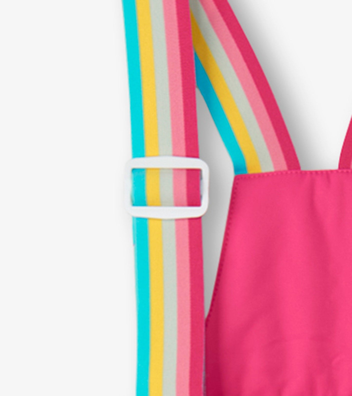 Bright pink snow pants with colorful striped suspenders, designed for kids. Ideal for winter activities.