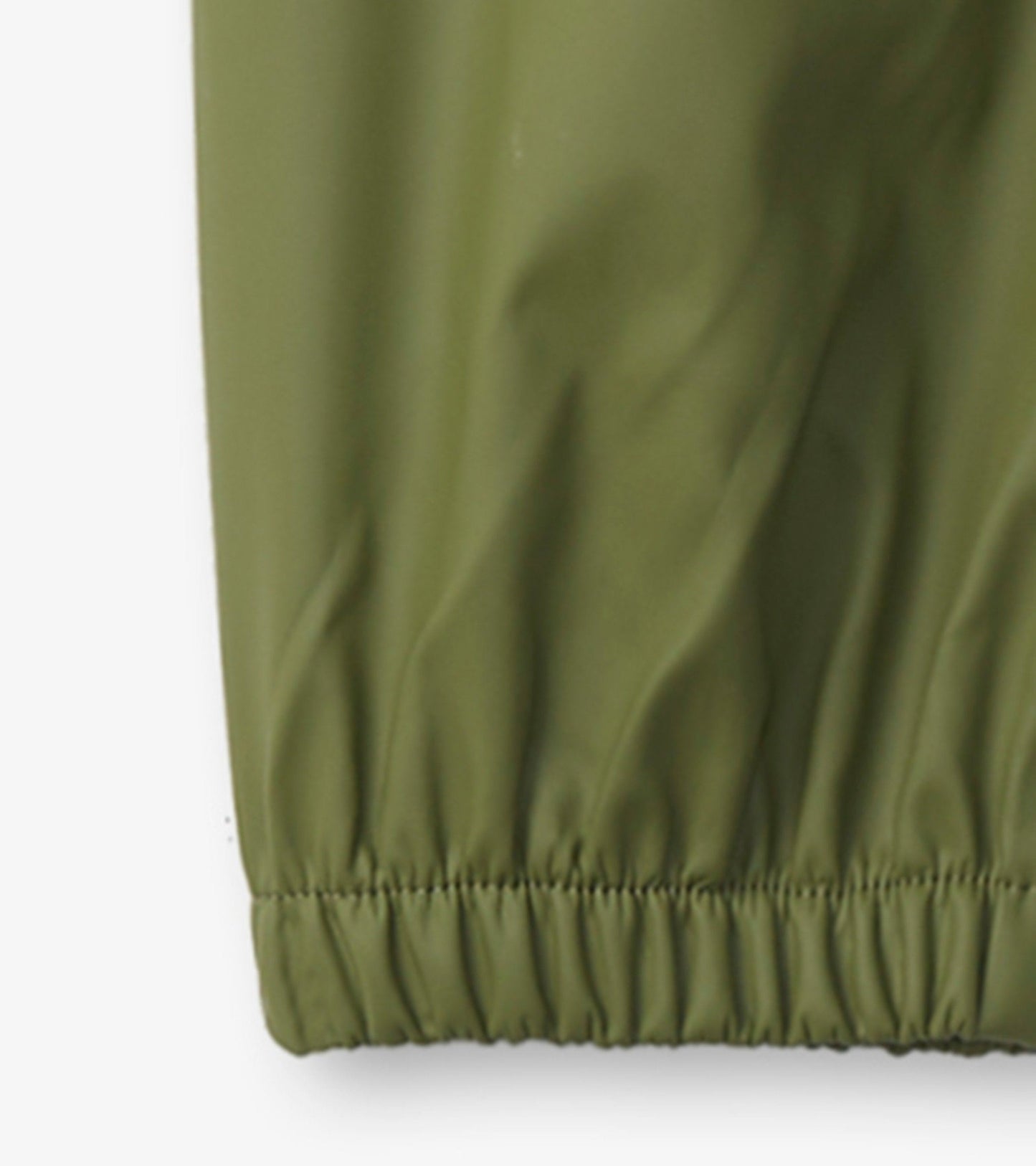 Forest green waterproof kids' rain pants with elastic cuffs for a snug fit. Ideal for outdoor play in wet weather.