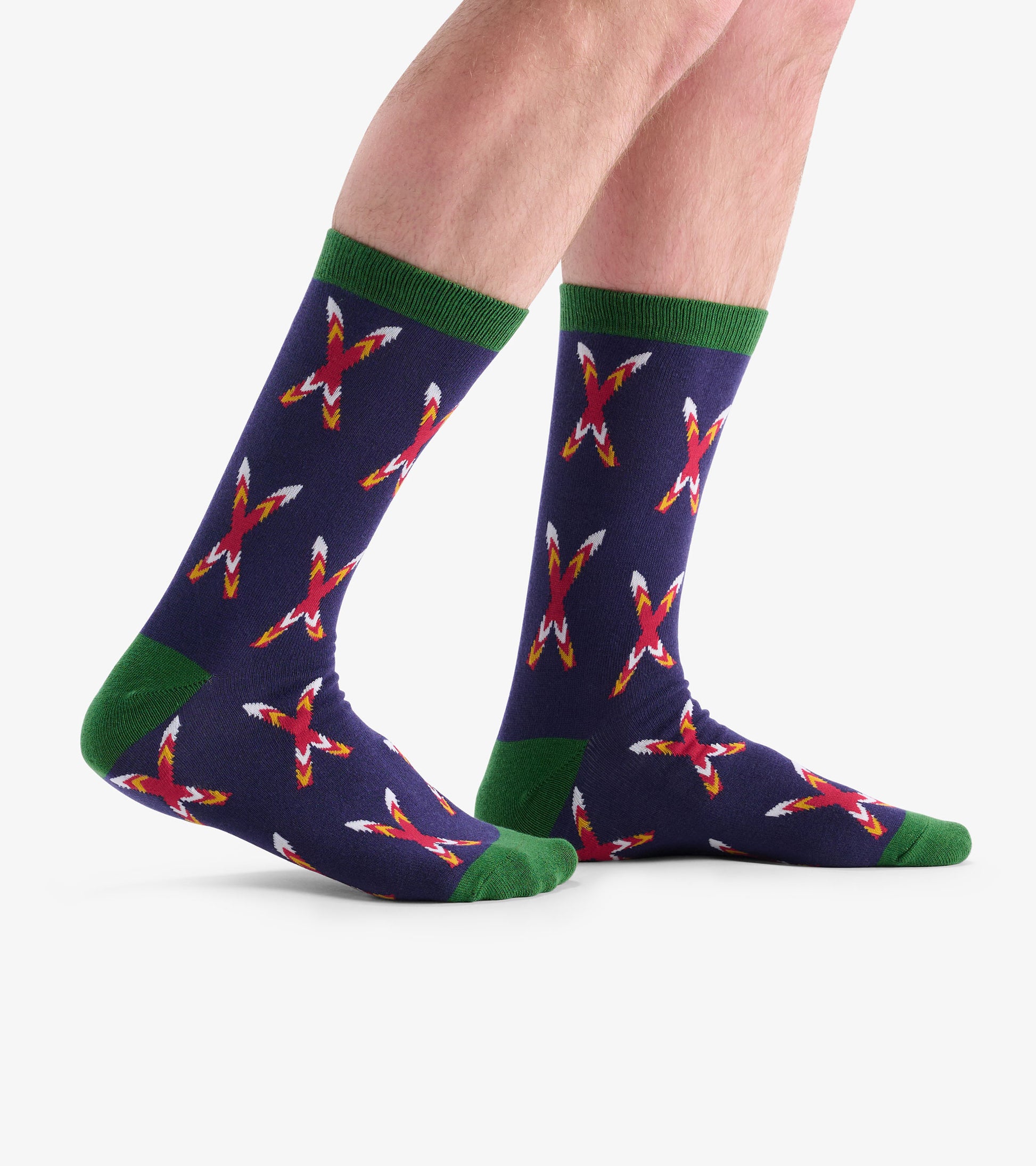 Navy socks with a crossed ski pattern in red and white, featuring green cuffs and soles, shown on feet.