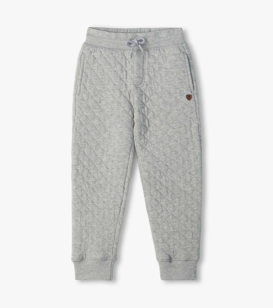Grey quilted jogger pants with drawstring waist, side pockets, cuffed ankles, and small H patch