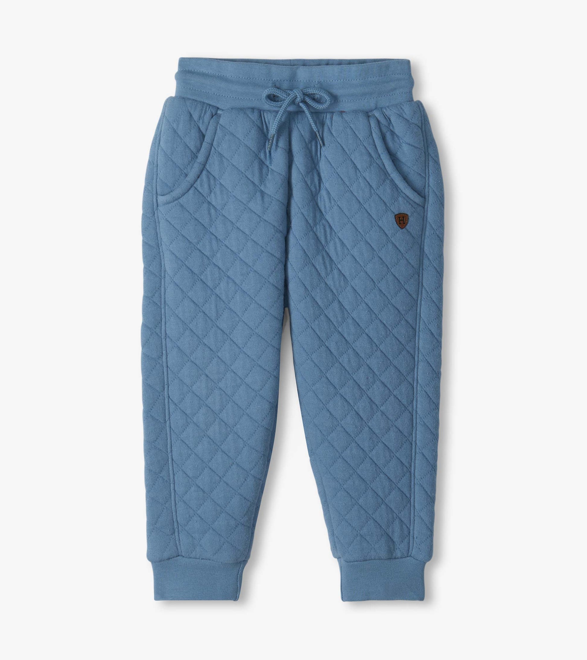 Faded blue quilted jogger pants with drawstring waist, front pockets, and ribbed ankle cuffs