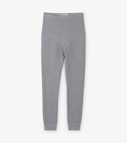 Silver shimmer cable knit leggings with a fitted design, featuring a soft waistband and tapered ankles.