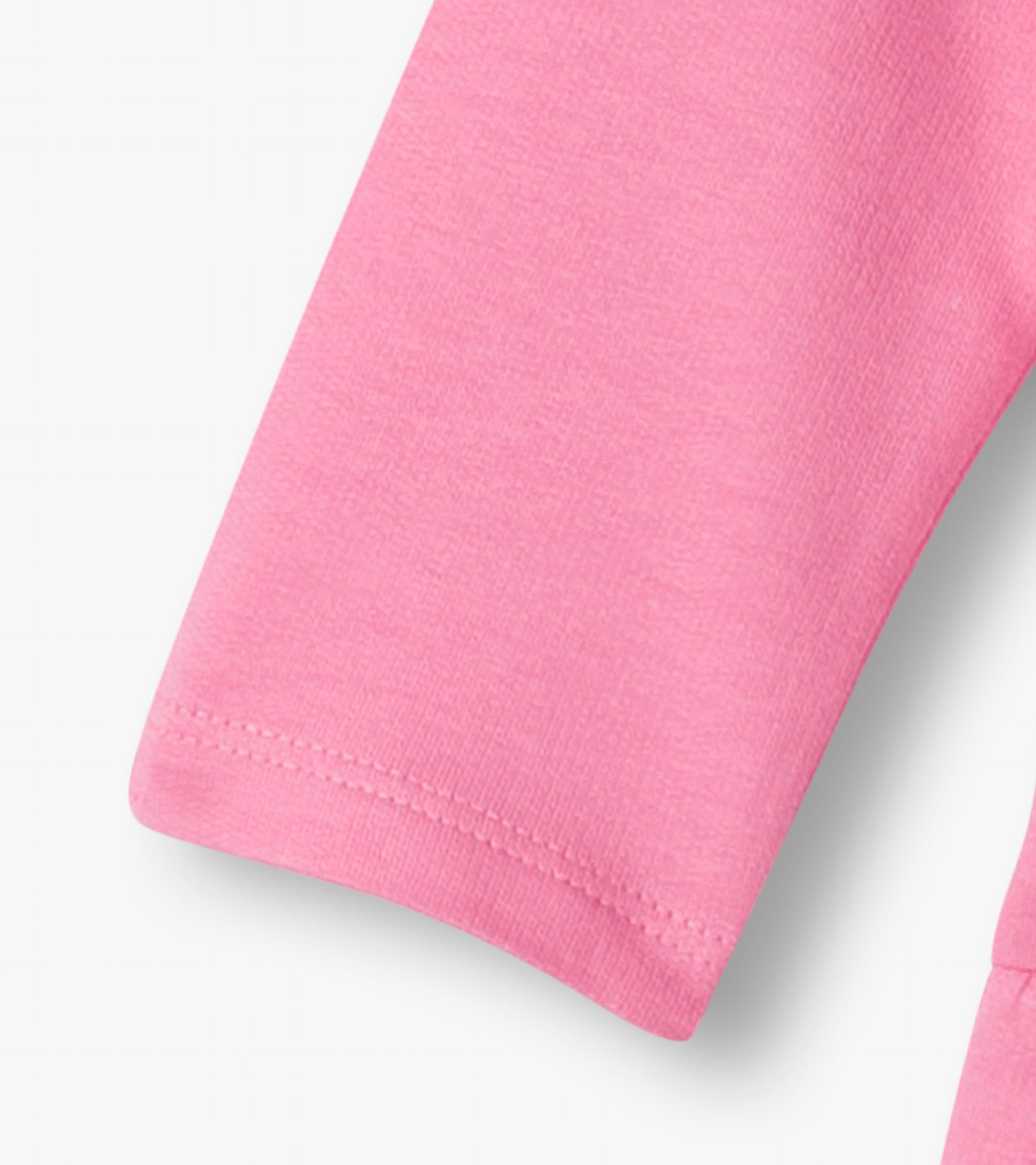 Close-up of a pink knit dress sleeve with stitched hem and soft fabric texture